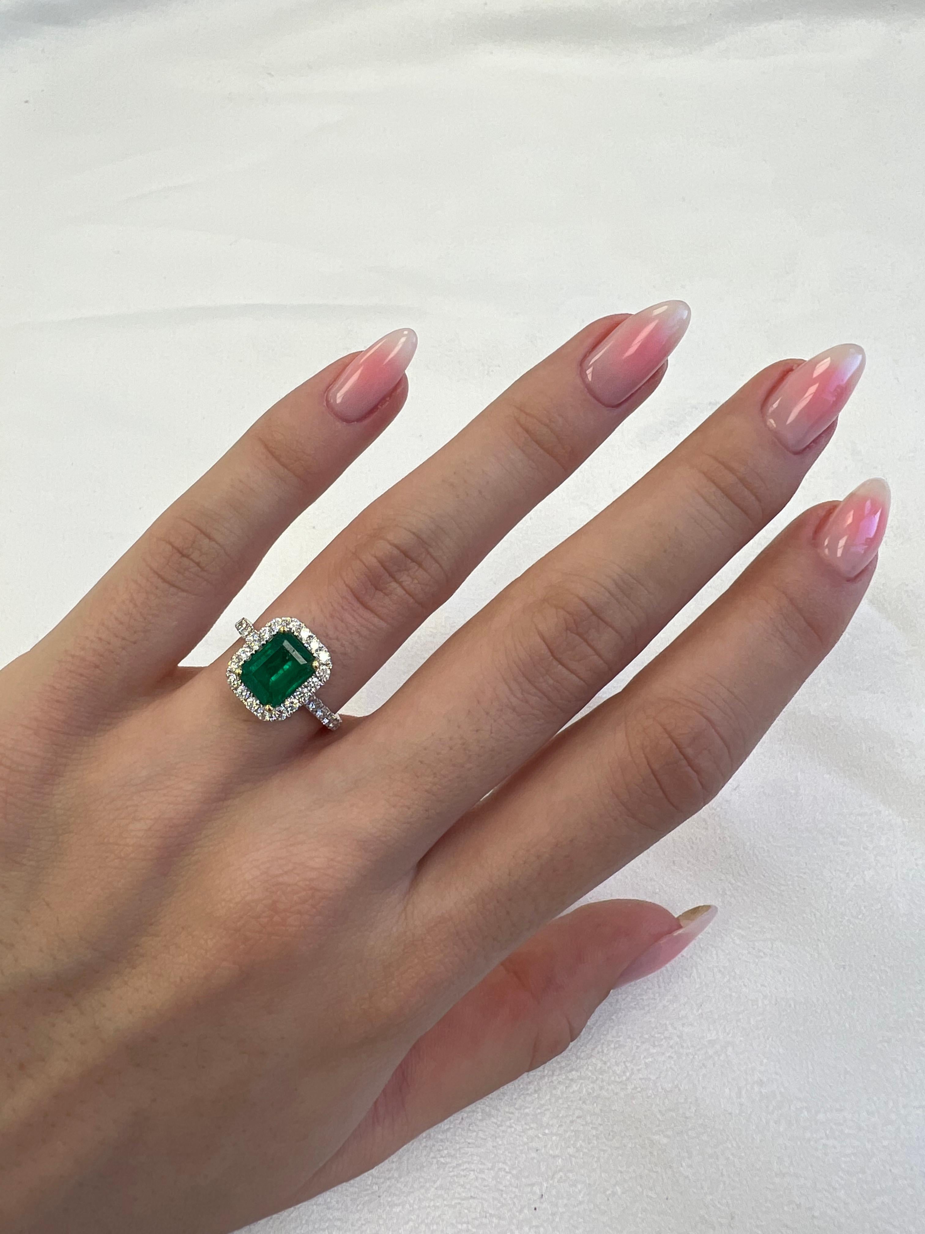Classic emerald and diamond halo ring, GIA certified. 
2.42 carats total gemstone weight.
1.71 carat emerald cut emerald, F2, GIA certified. Complimented by 30 round brilliant diamonds, 0.71 carats, F/G color and VS clarity. 18k white and yellow
