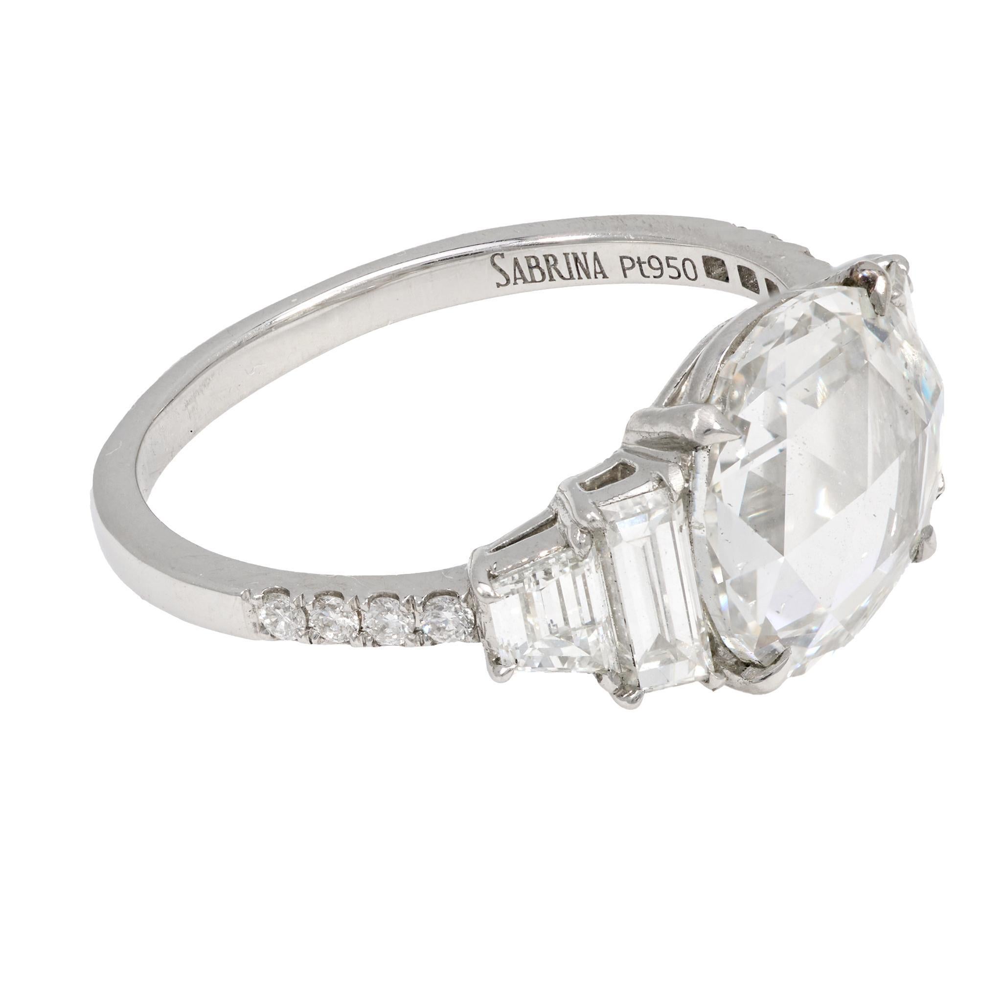 This vintage-inspired platinum engagement ring showcases a 2.45 carat GIA-certified rose cut diamond, softly luminous and framed by twelve sparkling round brilliant cut accents. With nearly a full carat of additional diamonds and refined