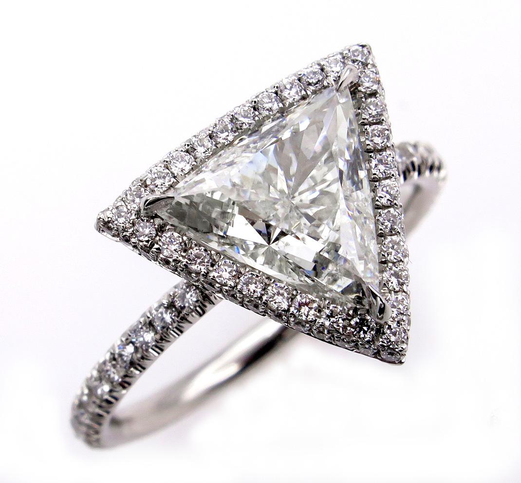 A ring for a Princess! SUPER Elegant and UNIQUE Micro Pave Platinum Diamond Halo Trillion Diamond ring from our Estate Collection. The Center is a 1.51ct Trillion, Triangular Brilliant Cut Diamond in J color, SI1 clarity (SUPER Brilliant, White and