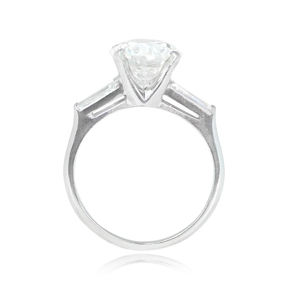 This exquisite ring showcases a central 2.53-carat GIA-certified old European cut diamond with J color and SI2 clarity, elegantly set in prongs. The center stone is beautifully complemented by tapered baguette-cut diamonds adorning the shoulders,