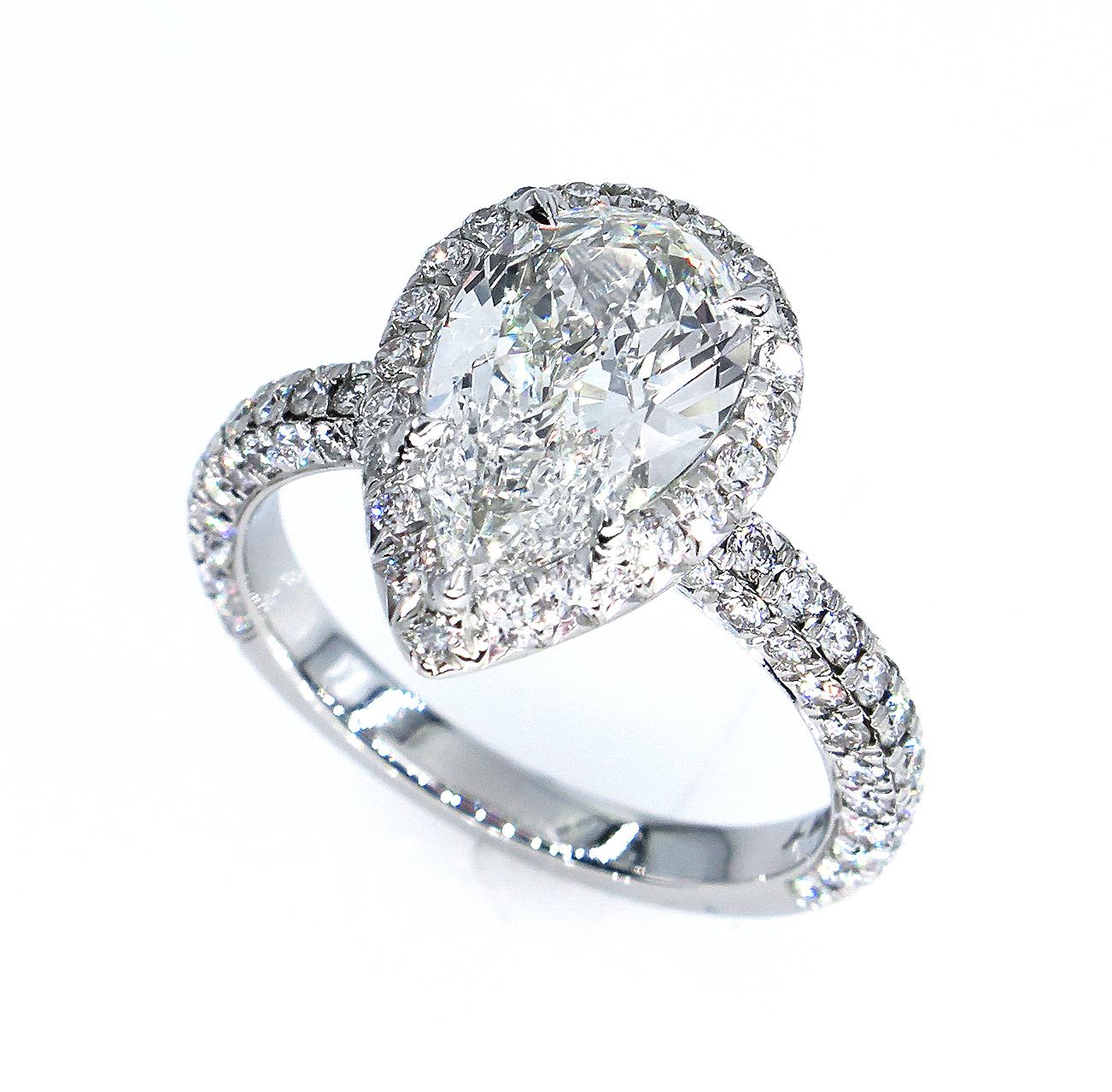 SUPER Elegant Timeless Micro Pave Platinum (stamped) Diamond Halo PEAR Diamond ring from our Estate Collection.
The Center diamond is 1.61CT J color, VS1 clarity GIA CERTIFIED. GREAT CUT and AMAZING BRILLIANCE!
The Diamond is White, Bright, and Very