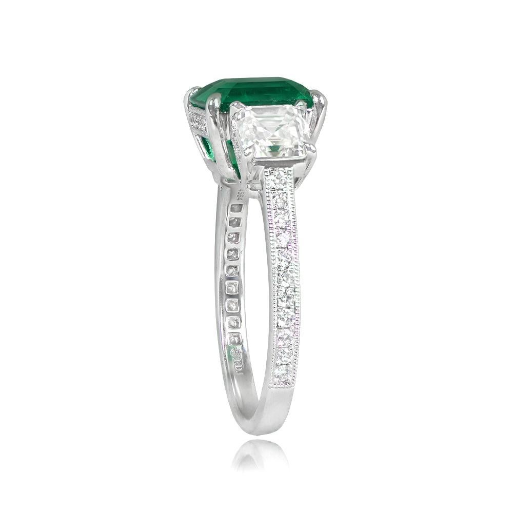 A remarkable platinum ring featuring a rare 2.68-carat certified Colombian emerald with no oil treatment, accompanied by two GIA-certified asscher-cut diamonds weighing 0.70 carats and 0.72 carats. These exceptional gemstones are prong-set and