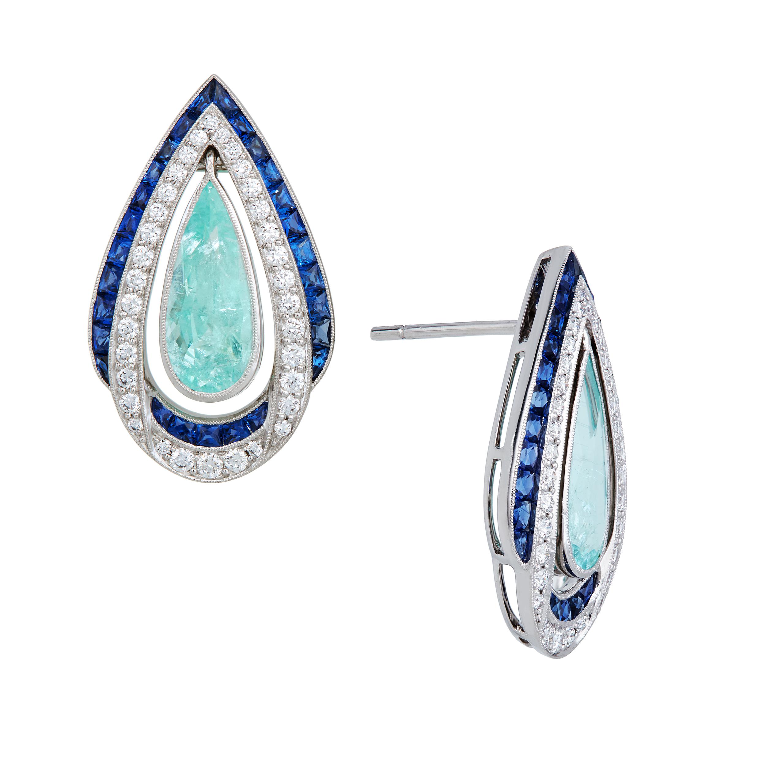 Notice how the Paraiba Tourmaline are attached to allow movement and interest while being surrounded by Ceylon Blue Sapphires and diamonds.  Handmade in 18 Karat White Gold.  These earrings are one of a kind and were designed and created alongside a