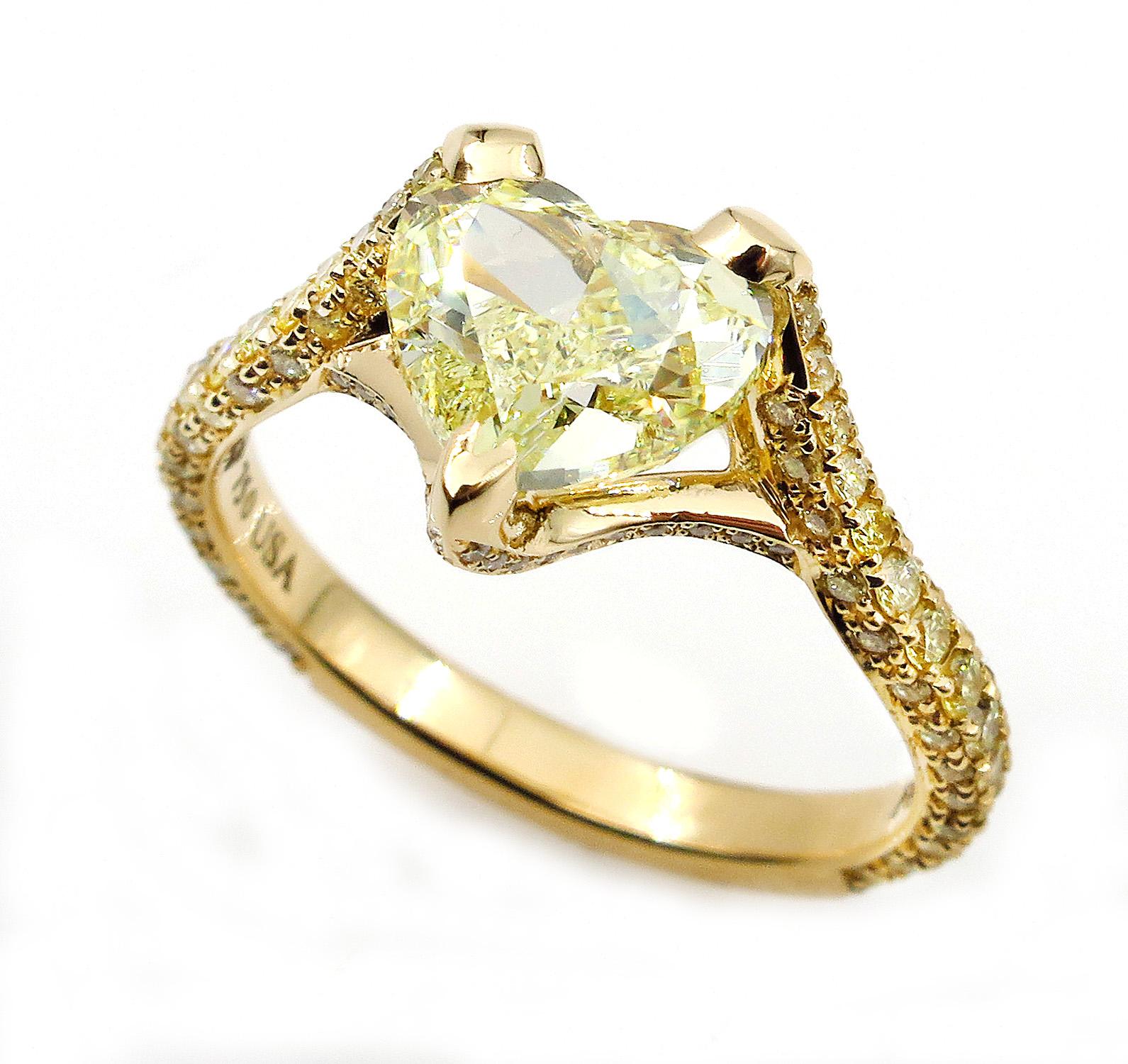 This is ring is just Beautiful! A gorgeous center Natural Fancy Color Diamond is ignited by bright fancy color diamonds that shimmer with real sparkle and flair. Exclusive, one-of-a-kind Estate Jewelry.
Very Bright Heart Shaped 2.06CT Center in