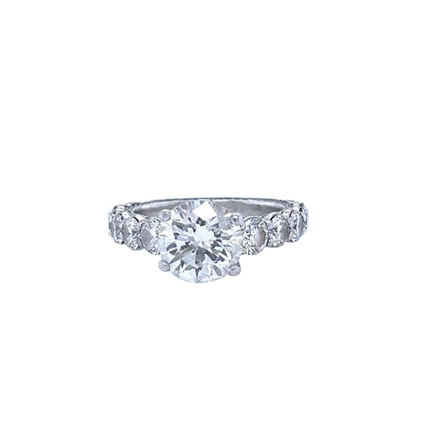 This beautiful Eternity Natural Diamond Ring Features a 2.70-carat center-round Round Cut Diamond Crafted in Platinum. It has Round cut diamonds, a VS1 / VS2 Clarity grade with K Color, GIA certified with Very Good polish, and Very Good Symmetry.