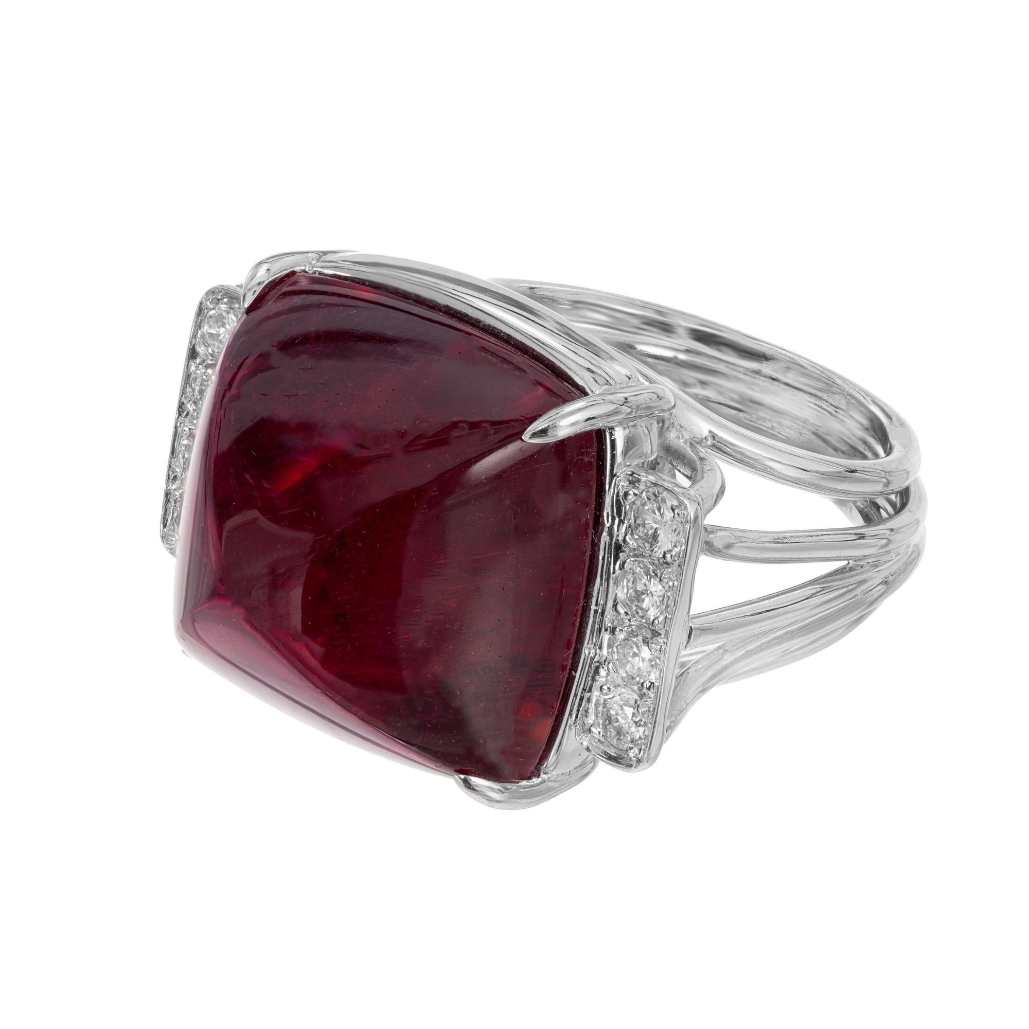 1950's Beautiful sugar loaf cut red Tourmaline Rubellite and diamond cocktail ring. This stunning rich red cabochon tourmaline is 27.49cts and is mounted in a platinum handmade wire gallery and shank. The stone is accented with 4 round cut diamonds