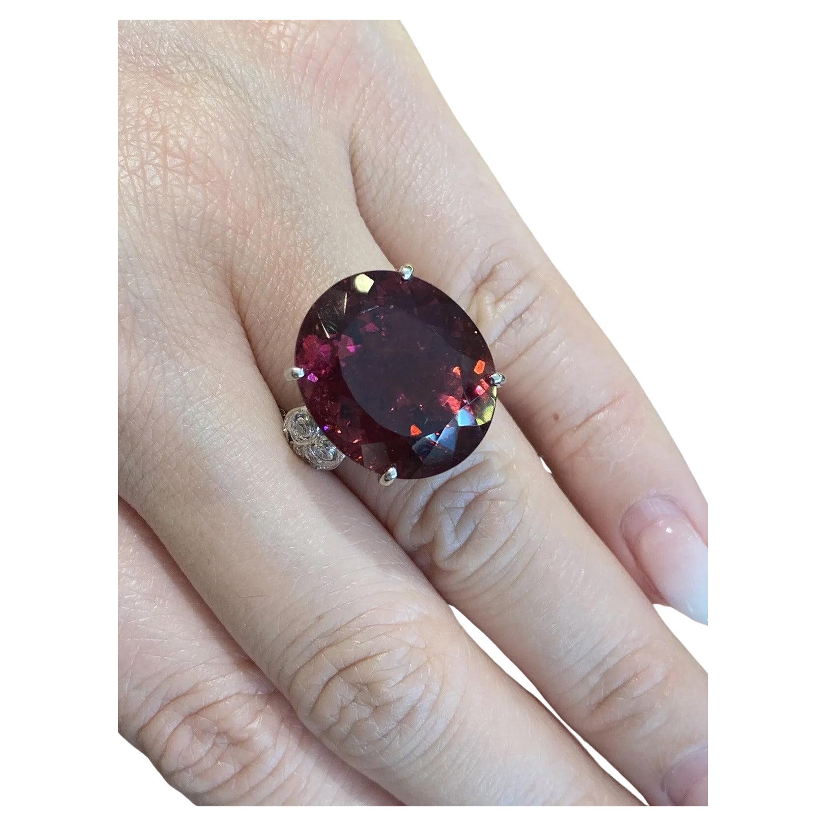 GIA Certified 27.58 Carat Oval Rubellite Ring with Diamonds in Platinum

Rubellite and Diamond Ring features an purplish red Oval shaped Rubellite accented by 24 Round Brilliant Diamonds set in Platinum.

Total rubellite weight is 27.58 carats and