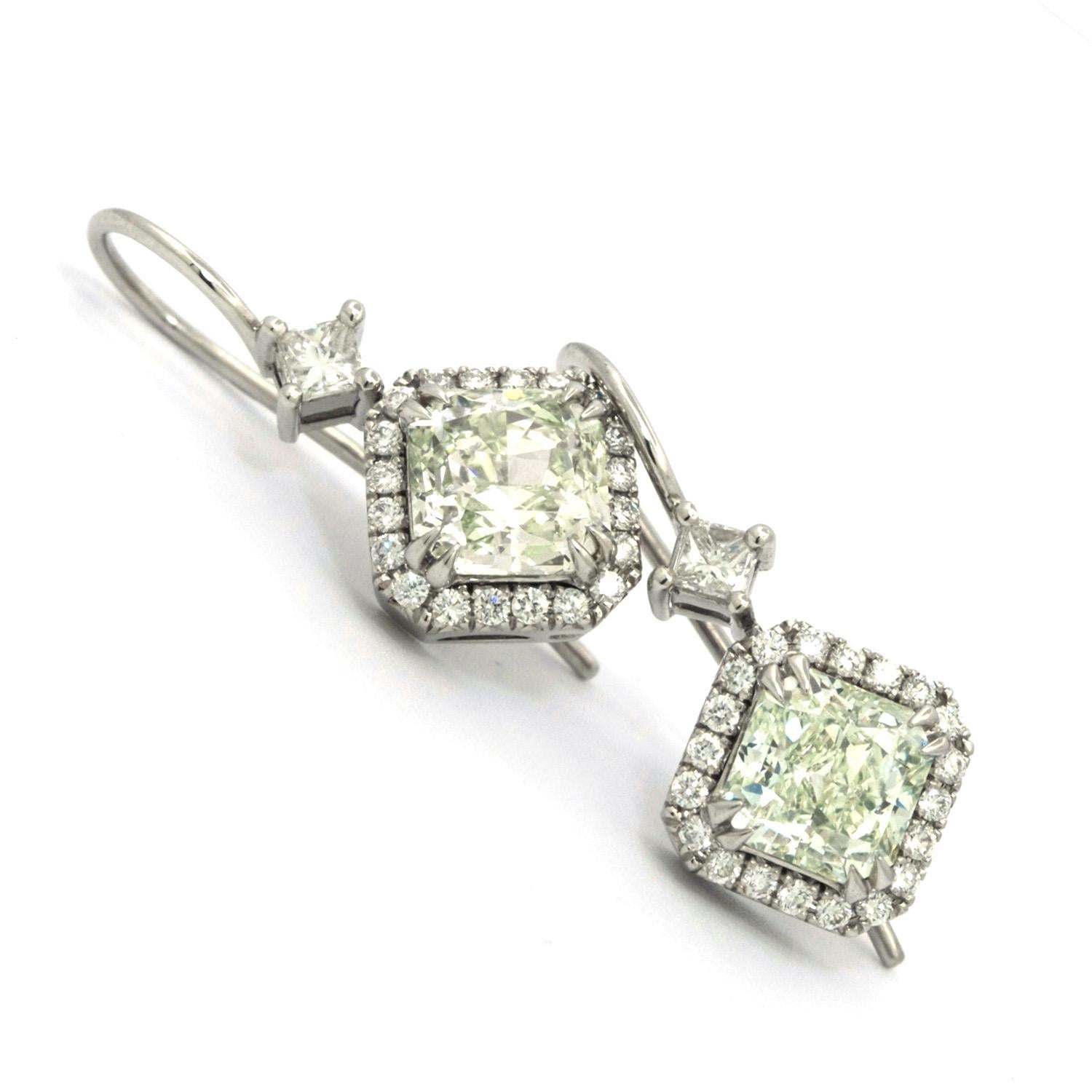 Two beautifully matching Radiant cut Green Diamonds, GIA certified.
One is a 1.26ct Radiant Light Yellow-Green VVS2, the other a 1.51ct Radiant Light Green SI1 Diamond, mounted along 0.40 carats of white Pave Diamonds and topped with a princess cut
