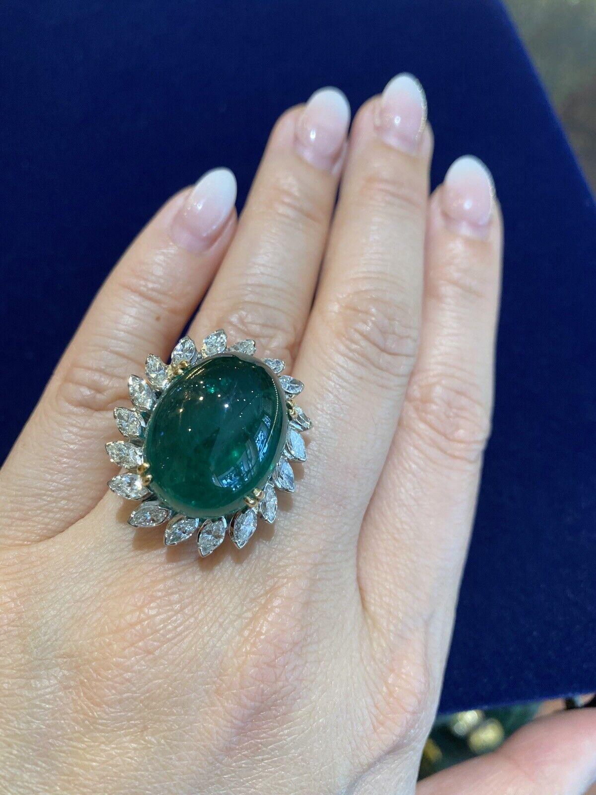 Emerald and Diamond Ring in Platinum
featuring
an Oval Cabochon Emerald
weighing 29.20 carats
GIA certified
Zambia Origin
F2 clarity enhancement

Platinum setting
with 18 Marquise Diamonds
weighing 3.00 carats estimated

Ring size is 6.75
Ring top