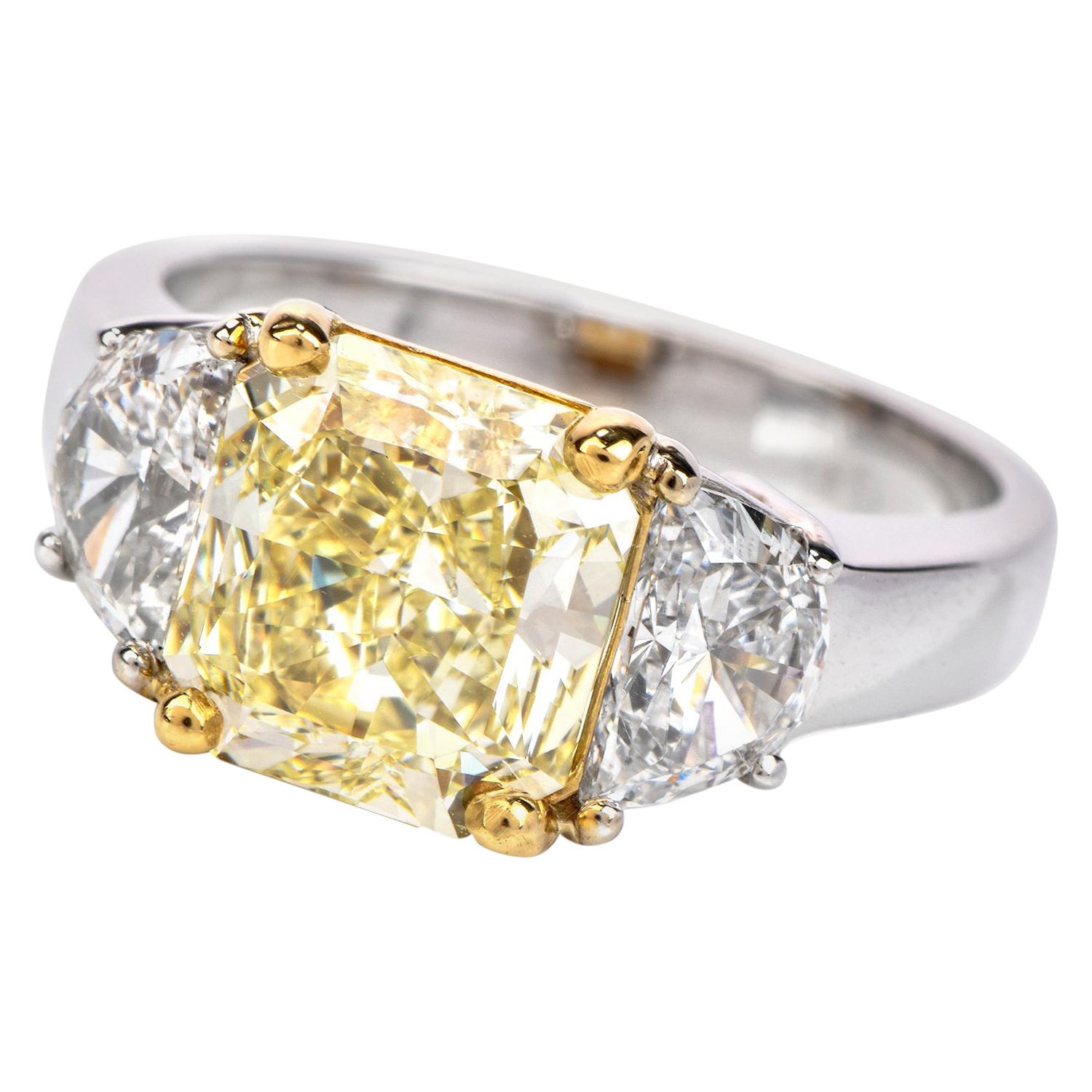 GIA 2.94 Carat Fancy Light Yellow Diamond 18 Karat Gold Radiant Three-Stone Ring