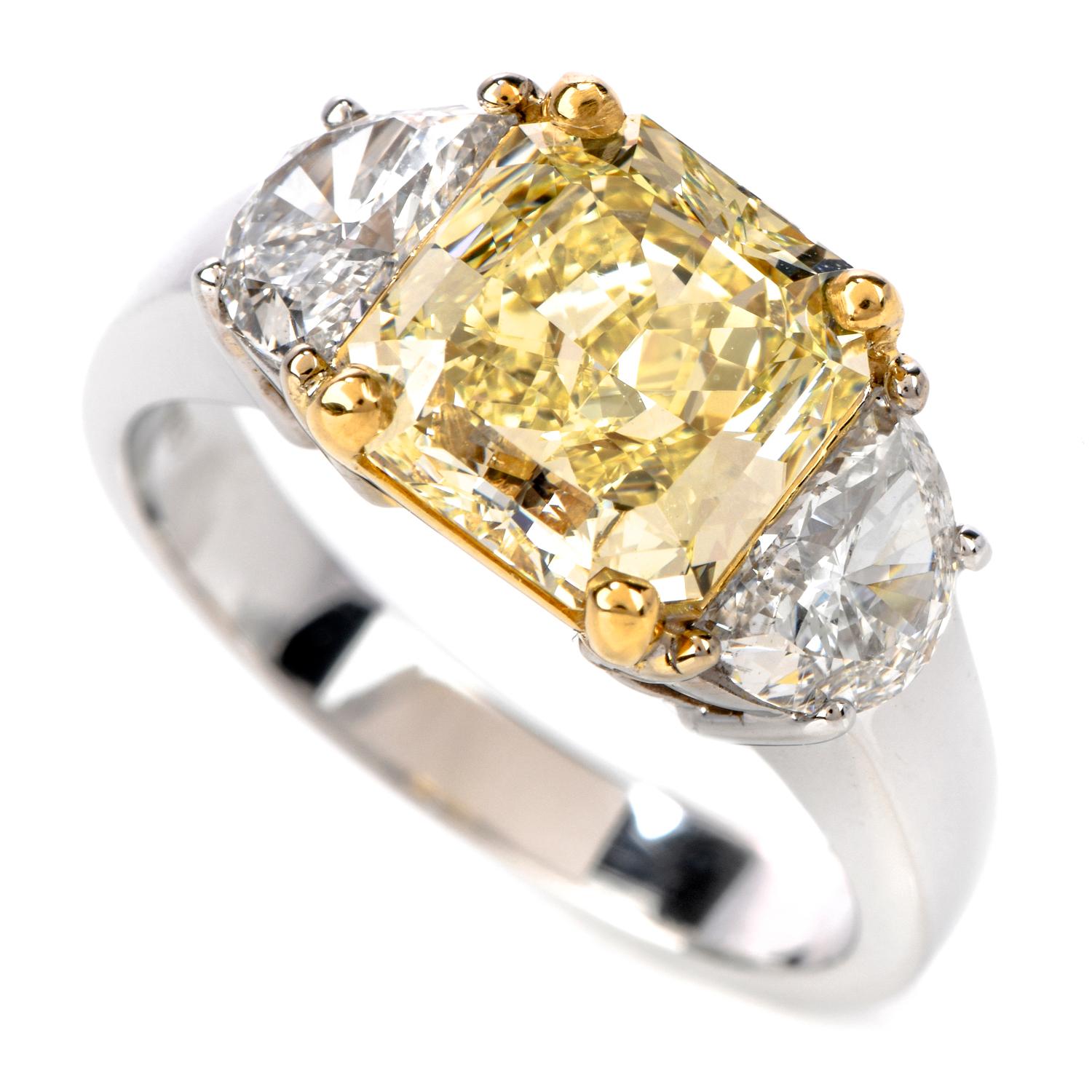Show your sweetheart that they are the sunshine in your life with this spectacular GIA Fancy Light Yellow Diamond 18K Gold Three Stone Ring!  

The center stone is of modified brilliant radiant cut, prong set,fancy light yellow, VS1 clarity, 2.08