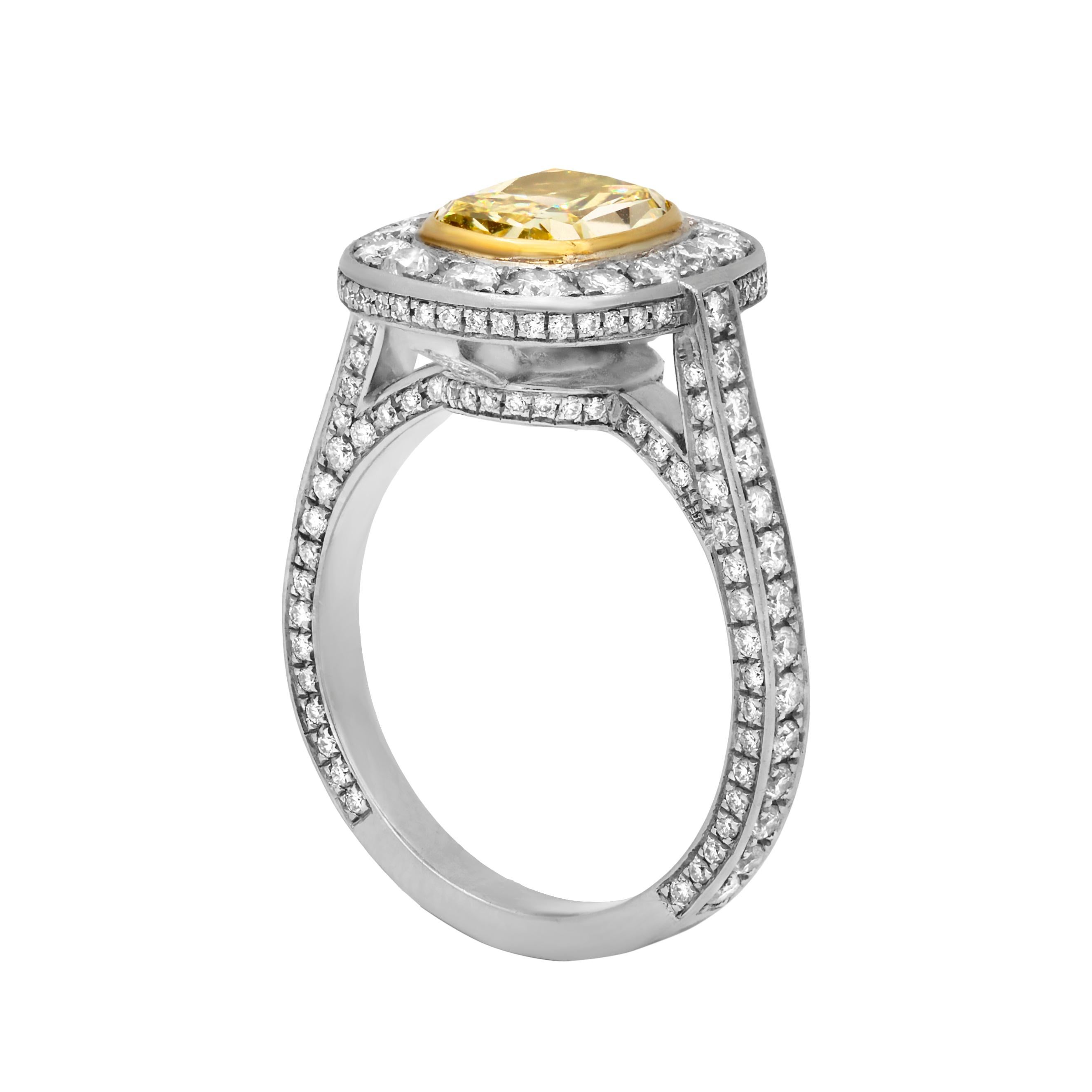 Platinum and 18K yellow gold engagement ring with 1.67 ct fancy intense yellow diamond with VS1 clarity and 1.31 carats of white diamonds going around the halo and band. GIA Certified 
Finger-size 6 