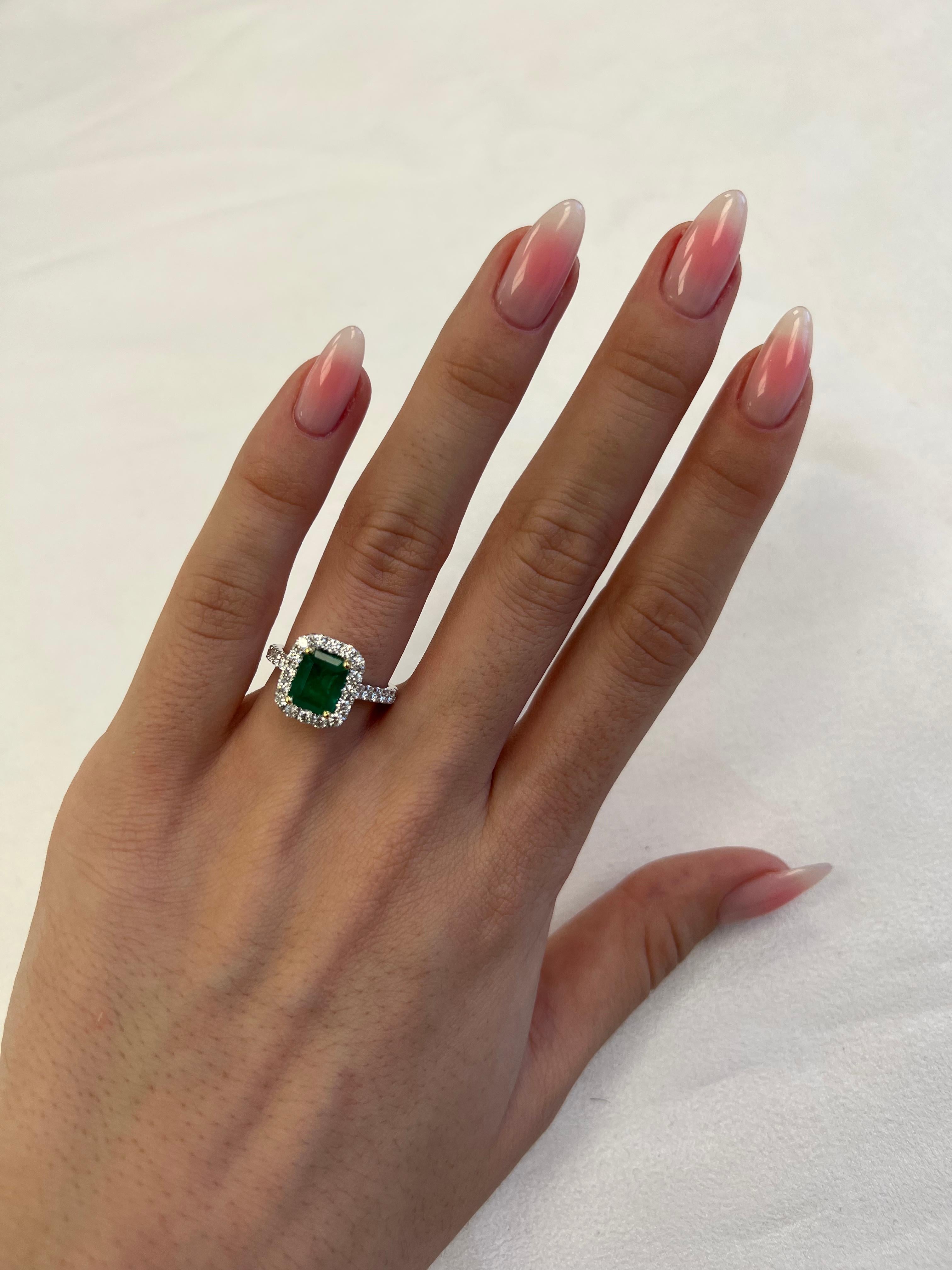 Classic emerald and diamond halo ring, GIA certified. 
2.98 carats total gemstone weight.
1.96 carat emerald cut emerald, F2, GIA certified. Complimented by 28 round brilliant diamonds, 1.02 carats, F/G color and VS clarity. 18k white and yellow