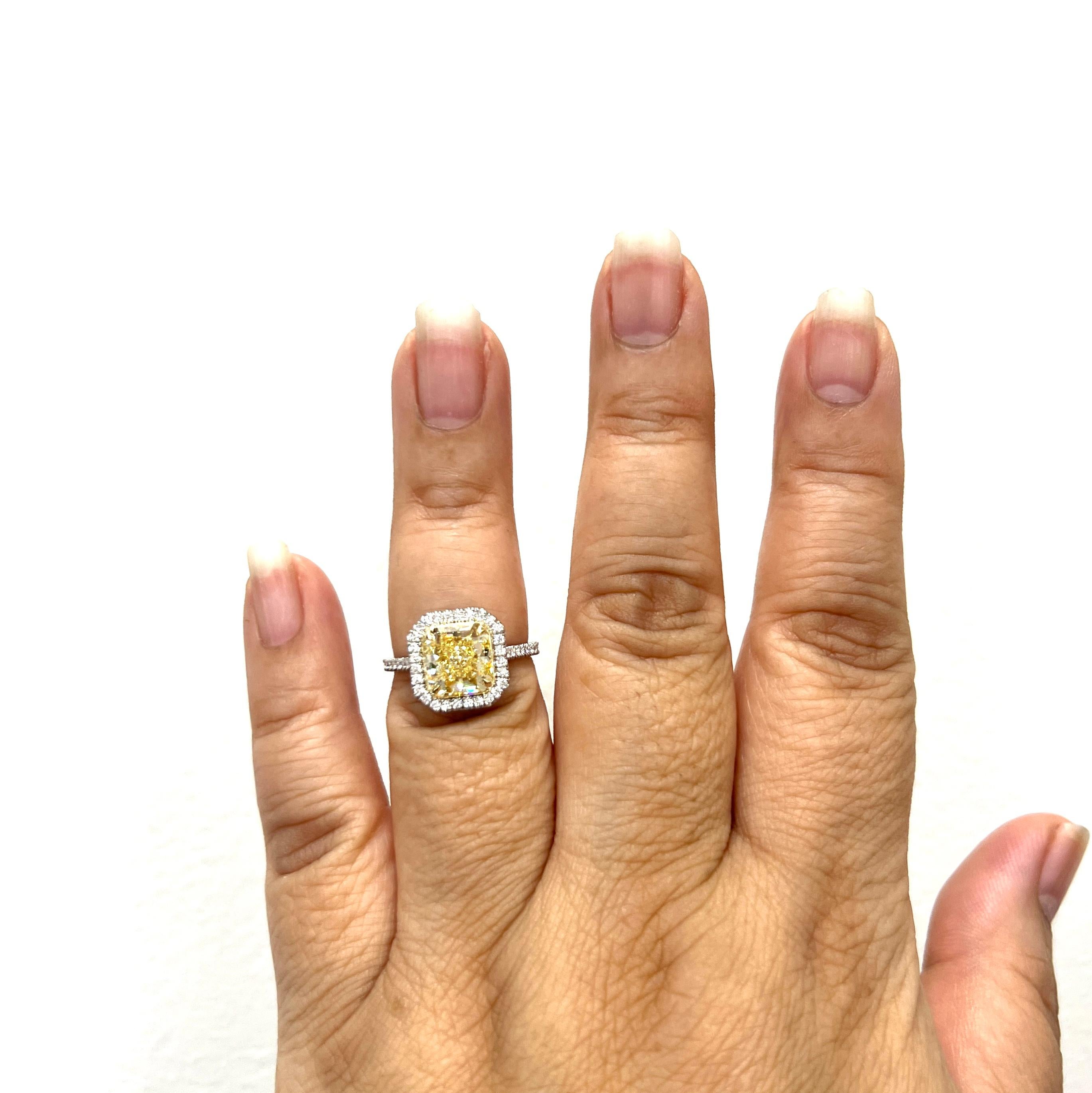 Gorgeous 3.07 ct. fancy yellow radiant diamond VS1 with 0.39 ct. good quality white diamond rounds.  Handmade in 18k yellow gold and platinum.  Ring size 6.5.  GIA certificate is included.