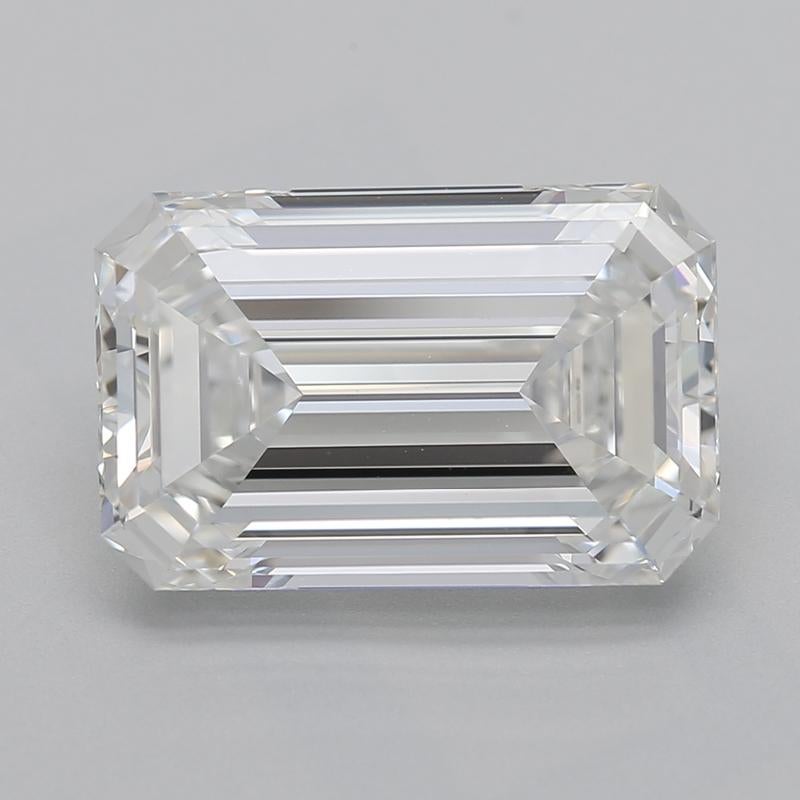 A magnificent diamond ring featuring a stunning emerald center stone, weighing an impressive 3.01 and boasting a flawless G and VS1. This exquisite piece is expertly crafted from white gold , offering a warm and radiant glow that enhances the