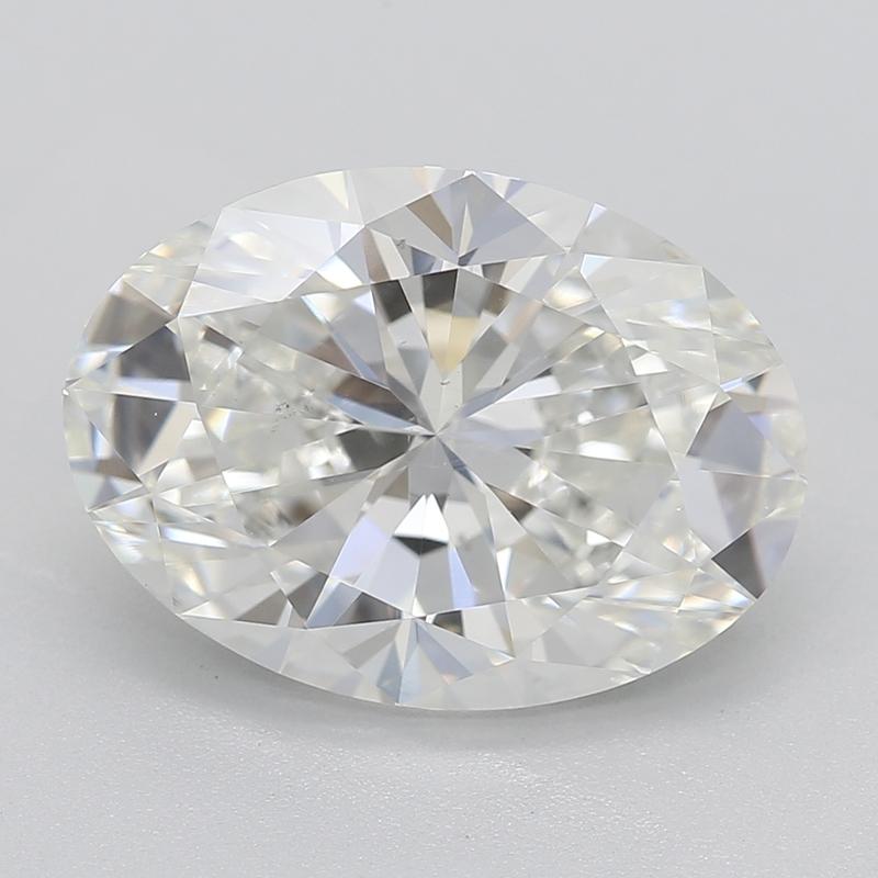 Handcrafted in New York, this stunning diamond ring features a captivating, GIA-certified center stone of oval diamonds weighing 3.01 and graded H and SI1. The brilliance and fire of the center stone are beautifully complemented by a row of