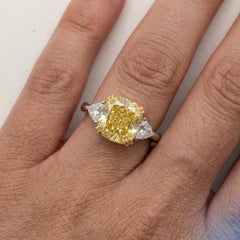 GIA 3.03 Carat Fancy Intense Yellow VVS1 Diamond Three Stone Platinum Ring