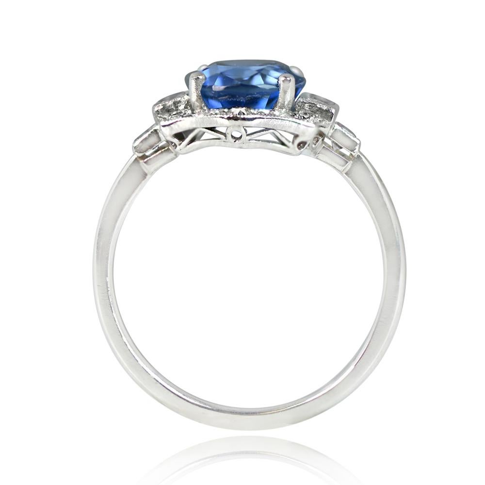 A captivating platinum ring showcases a GIA-certified 3.15-carat natural non-heat treated sapphire at its center. The sapphire is embraced by a halo of old European and baguette-cut diamonds. The shoulders feature two elegant baguette diamonds. The