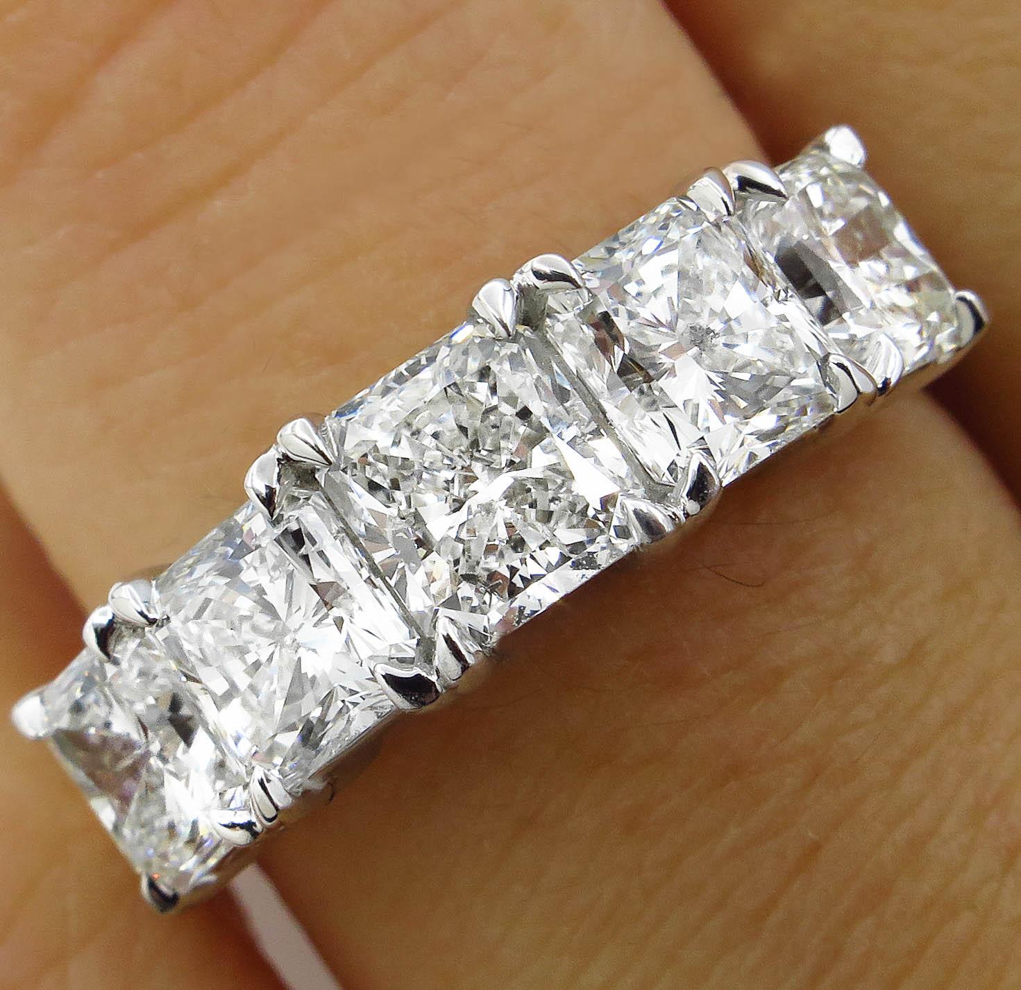 A Breathtaking Vintage HANDMADE Platinum (stamped) Diamond 5 Stone Engagement Wedding band ring. The Prong Set Radiant Cut Diamond is 0.75CT; GIA Certified in J color I1 clarity; with measurements of 5.29x4.86x3.34mm. GIA report # 6193782878.
It is