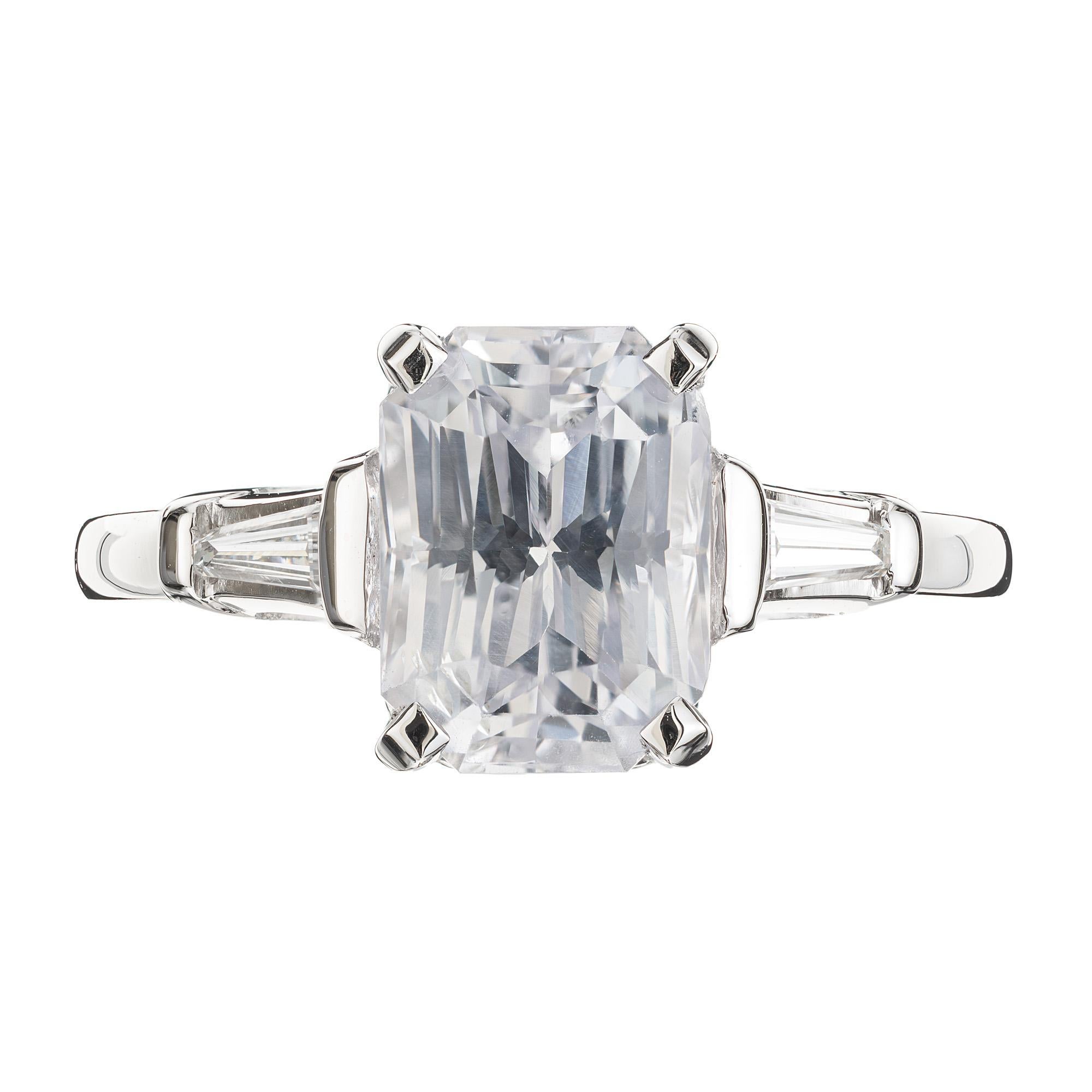 1940's Colorless sapphire and diamond three-stone engagement ring. GIA certified octagonal corner cut 3.18ct cut. sapphire mounted in a platinum setting with 2 tapered baguette diamonds. This color sapphire and size makes this a rare and unique