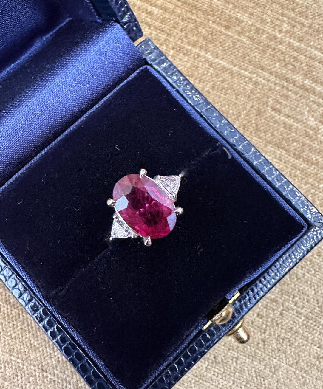 GIA CERTIFIED 3.19 Carat Oval Burma Ruby Three-Stone Ring in Platinum

Oval Ruby Three-Stone Ring features a large Oval Brilliant cut Red Ruby with two Trillion Diamonds set in platinum. The ruby originates from Burma(Myanmar) and has been heat