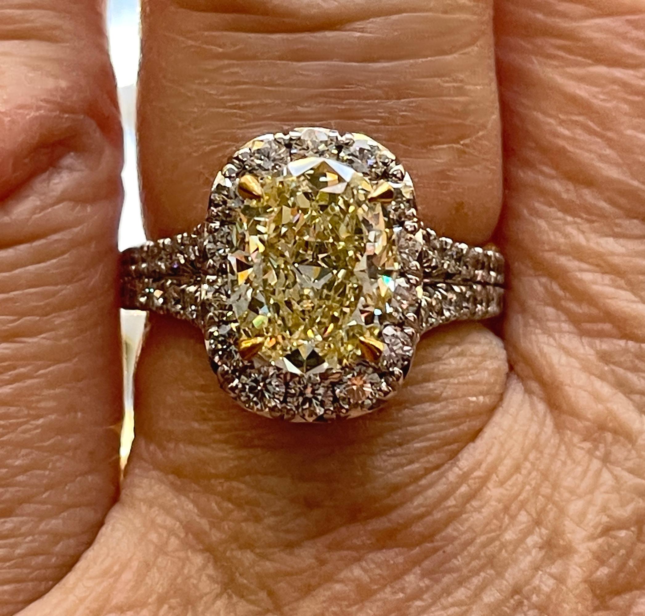 GIA 3.23 Carat Natural Fancy Yellow VS1 Oval Diamond Wedding 18K Gold Halo Ring For Sale 4