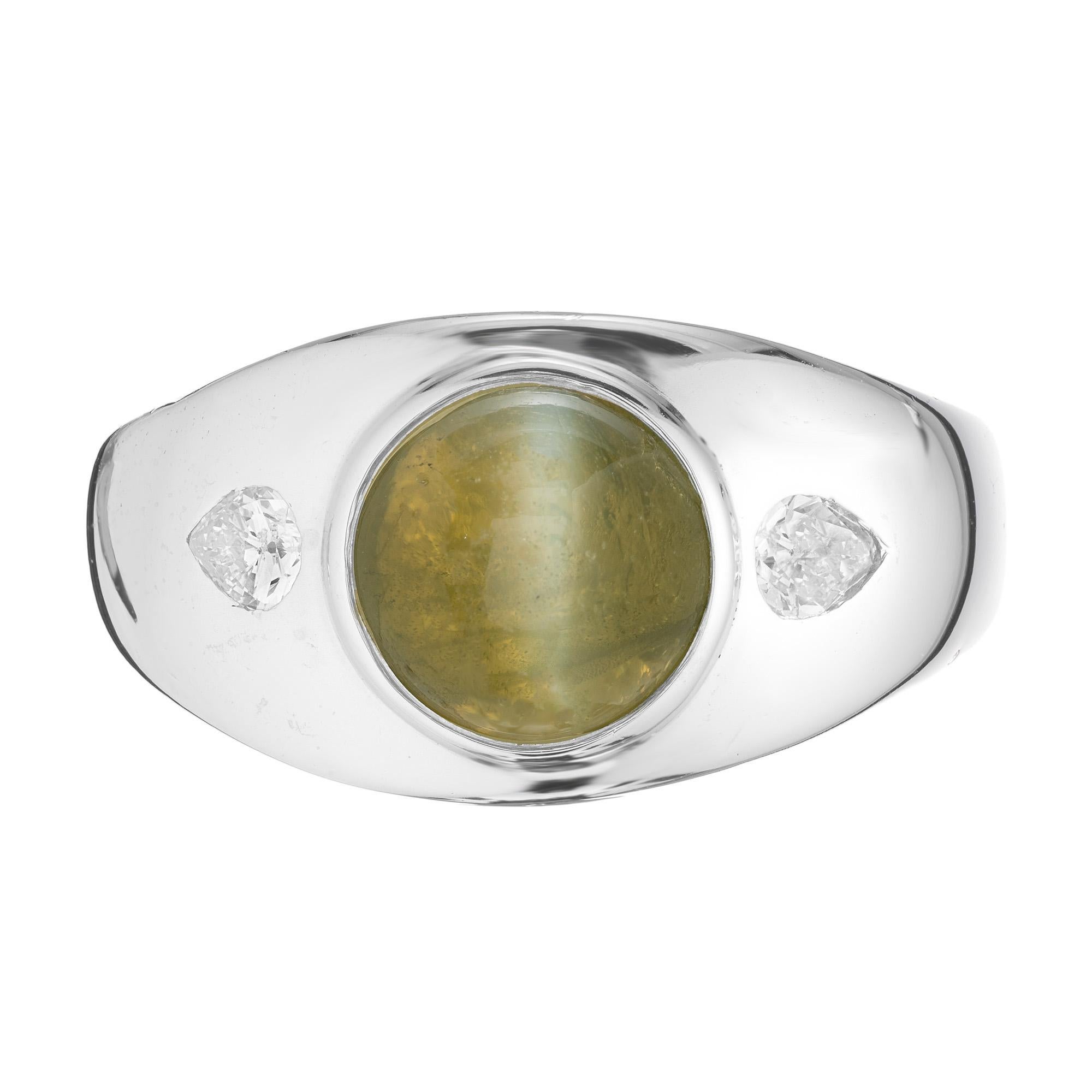 1950's Milk and Honey round mens chrysoberyl cats eye platinum ring circa 1950. Set with a unique Chrysoberyl Cat's Eye center stone. Mounted in a platinum setting and accented with a pear shaped diamond on each side of the stone. The center stone
