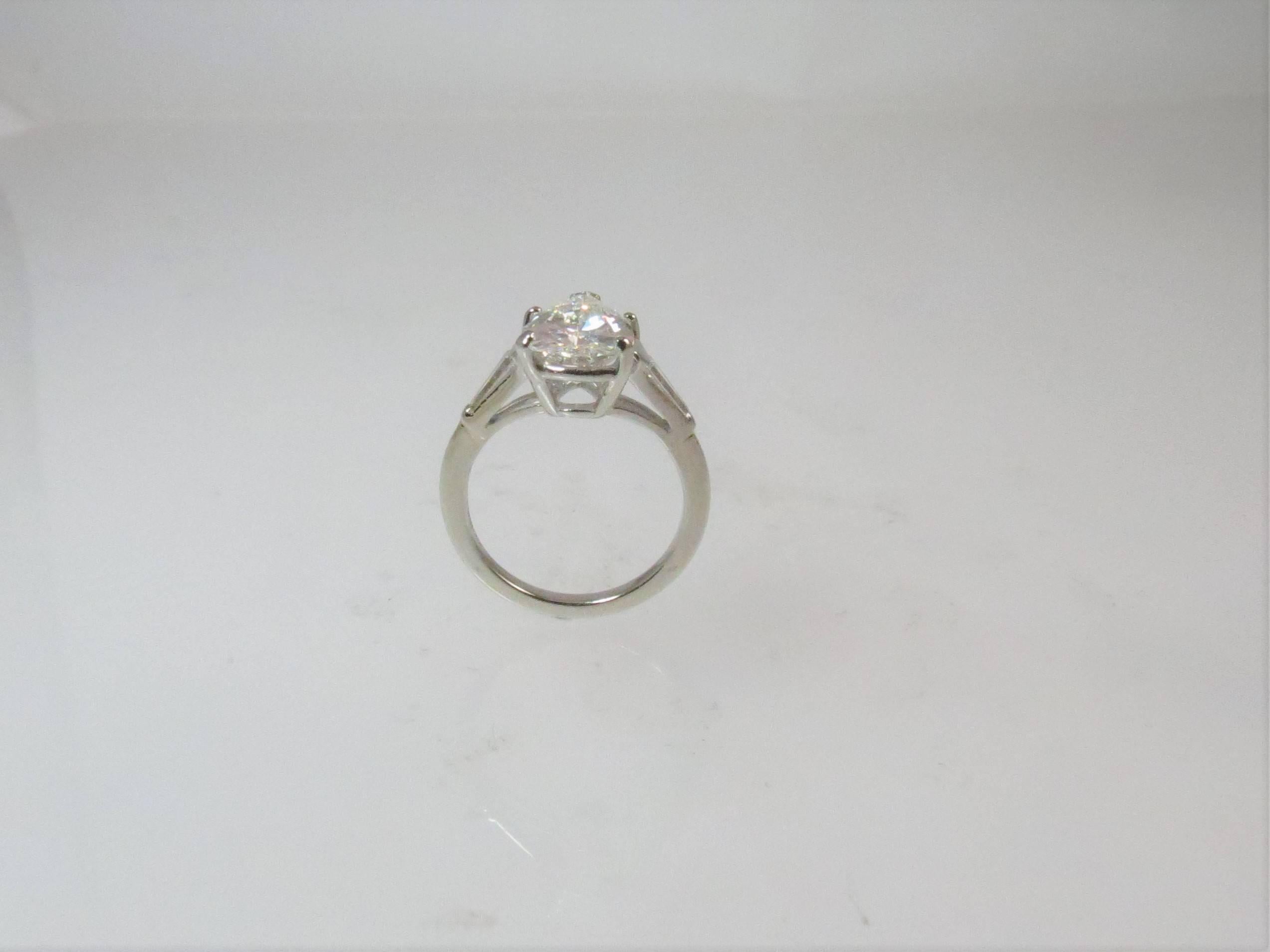 Platinum engagement ring, prong set with GIA certified 3.34 Pear shape diamond, I color, SI1 clarity and two tapered baguettes weighing .30cts, H color, VS clarity
Finger size 6, may be sized