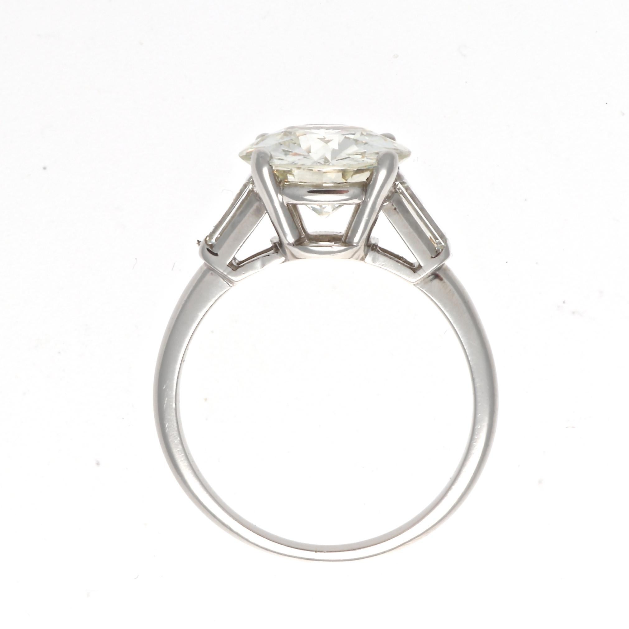 A sentiment of tradition but most importantly love that has been passed on from generation to generation. Featuring a 3.44 carat round brilliant cut diamond that is GIA certified as L color, VS2 clarity. Elegantly accented on either side by a single