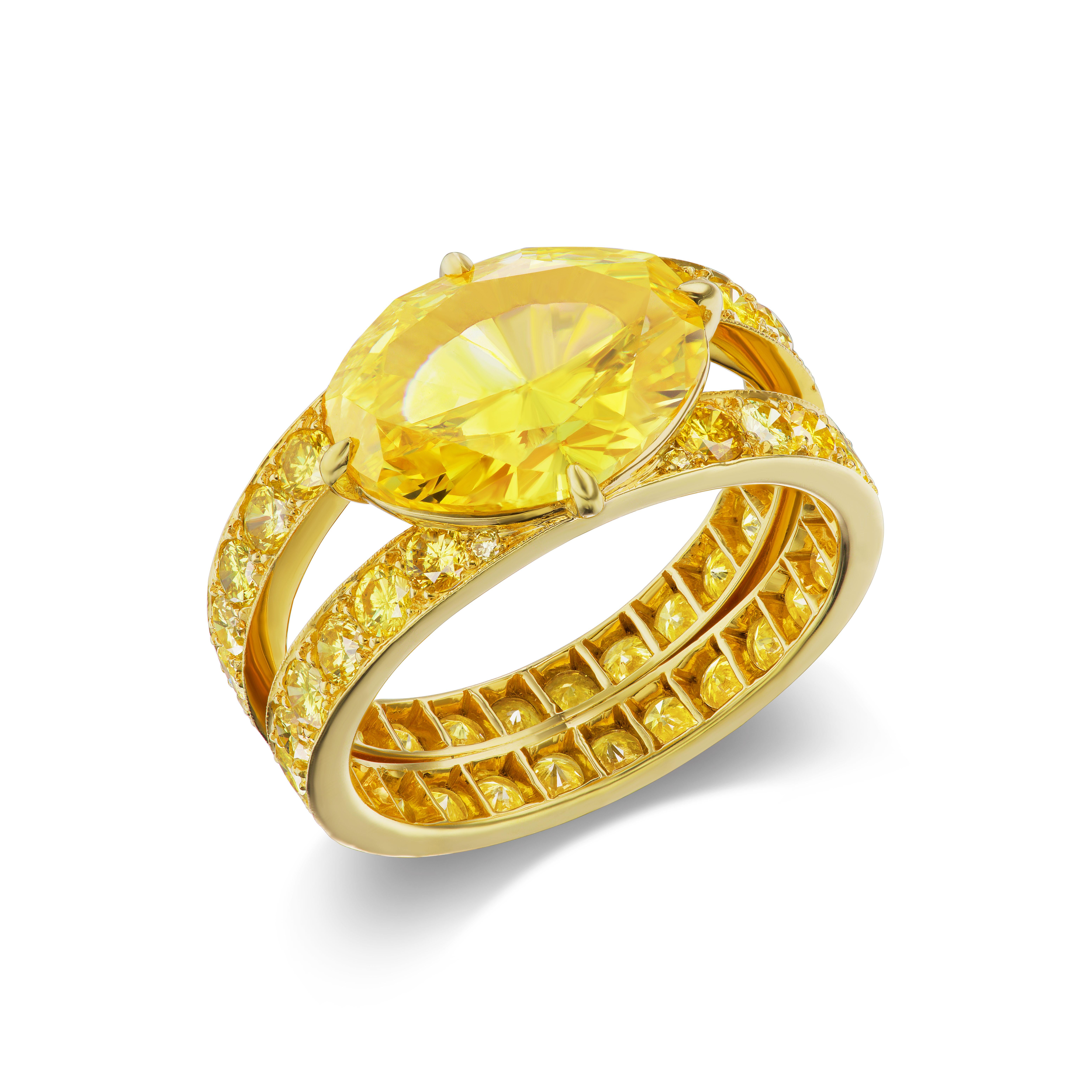 This 3.51 carat vivid yellow oval diamond exhibits an incomparable saturation, hue, and brilliance. It is mounted 