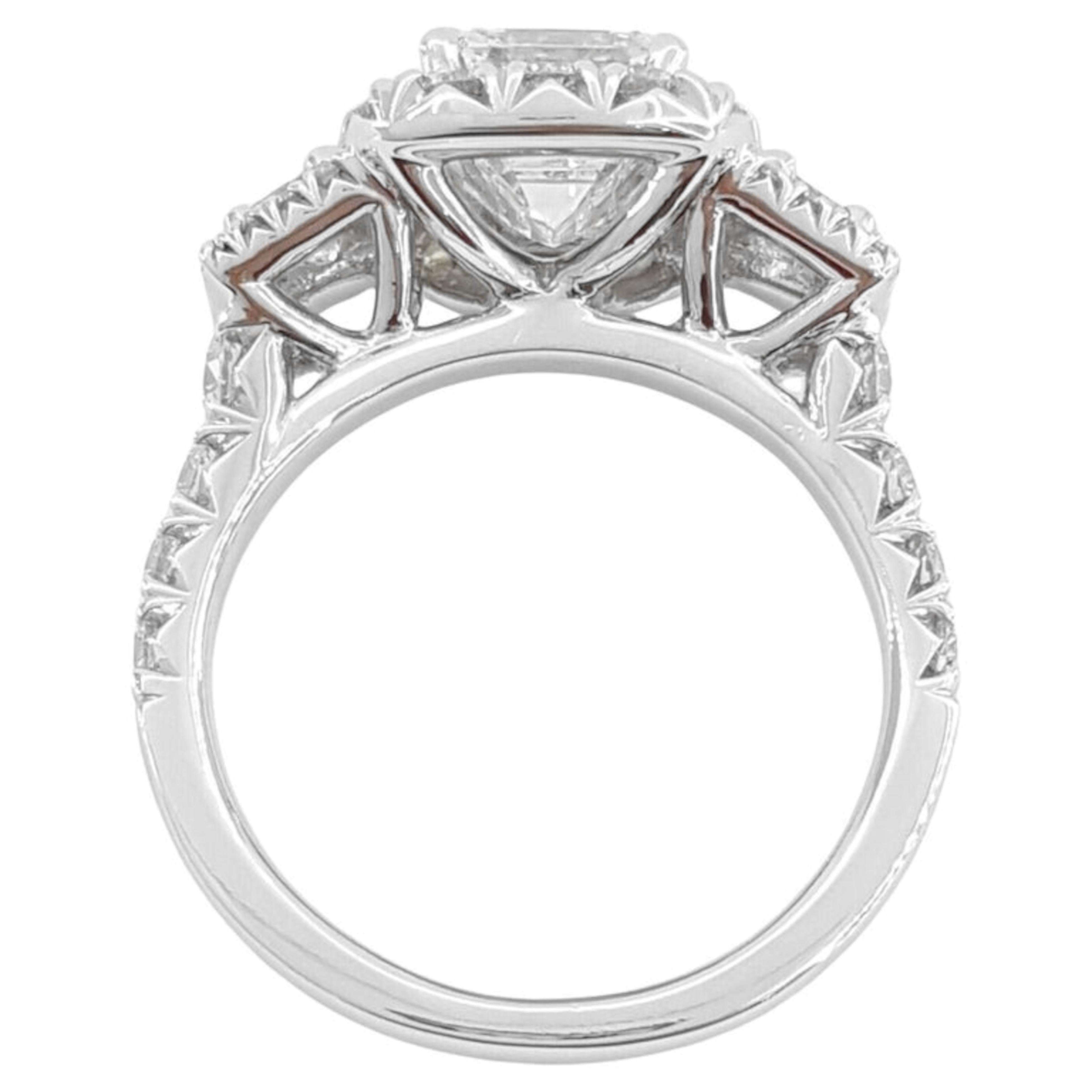  2.01 ct emerald cut diamond graded G in color and VS2 in clarity. Its beauty is enhanced by very good polish, very good symmetry, and medium blue fluorescence.

Henri Daussi diamond ring. Surrounding the center stone is a halo of 42 natural round