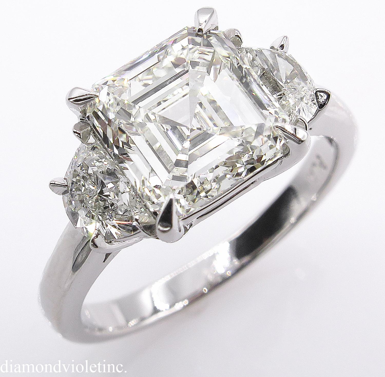 A Breathtaking Estate HANDMADE PLATINUM (stamped) Diamond Three-Stone Engagement ring dazzles GIA Certified 3.00ct Asscher cut Center Diamond in K color and VVS1 clarity (Very Bright, Near-Flawless) with measurements of 8.09x7.86x5.13mm.
It is set