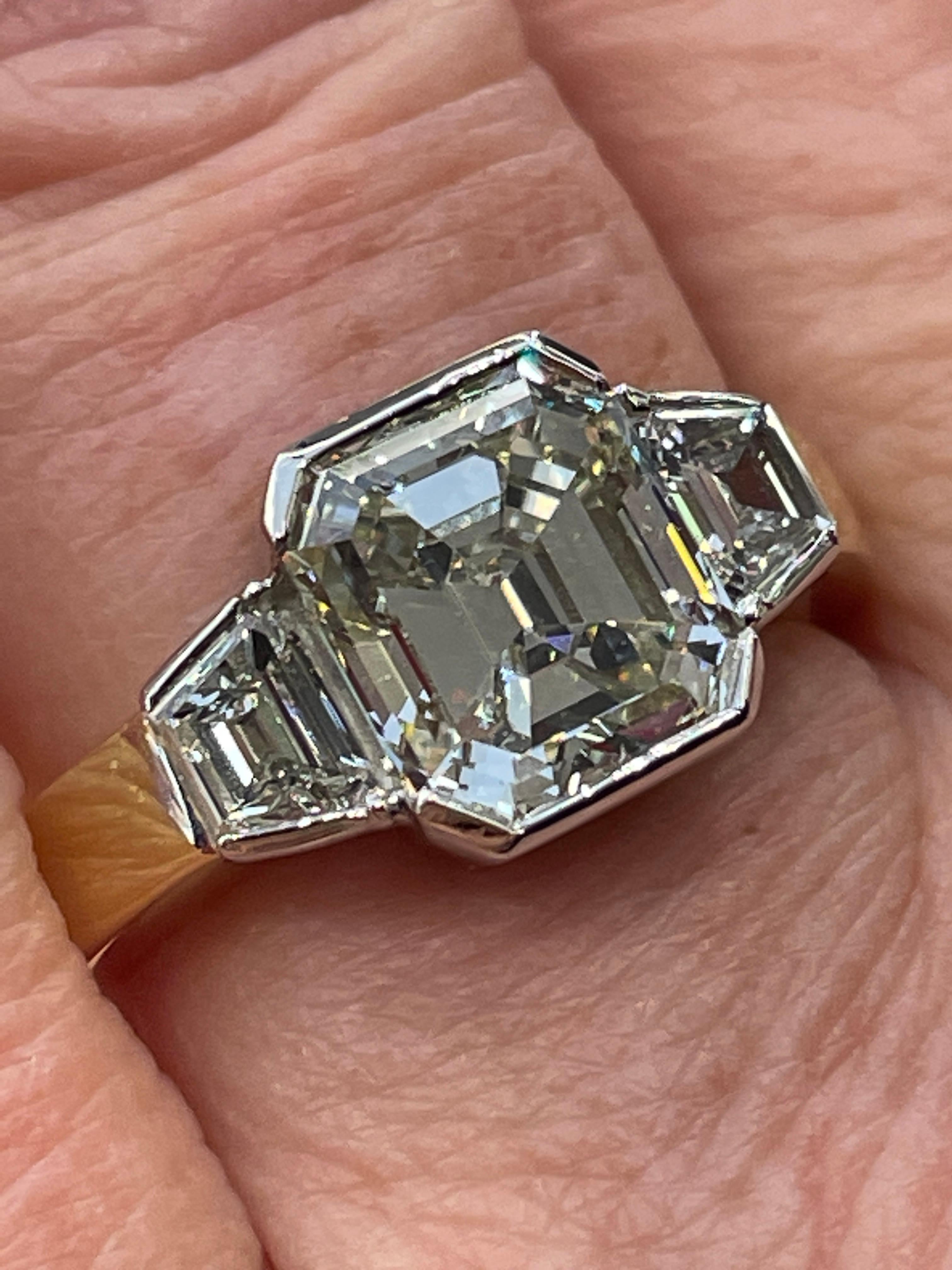 Breathtaking Estate HANDMADE PLATINUM and 18K Yellow Gold (stamped) Emerald Diamond  Three-Stone Engagement Ring.

All the Step cut Diamonds are Masterfully set into Platinum Bezel setting. The center Emerald Diamond is GIA Certified 3.04ct with