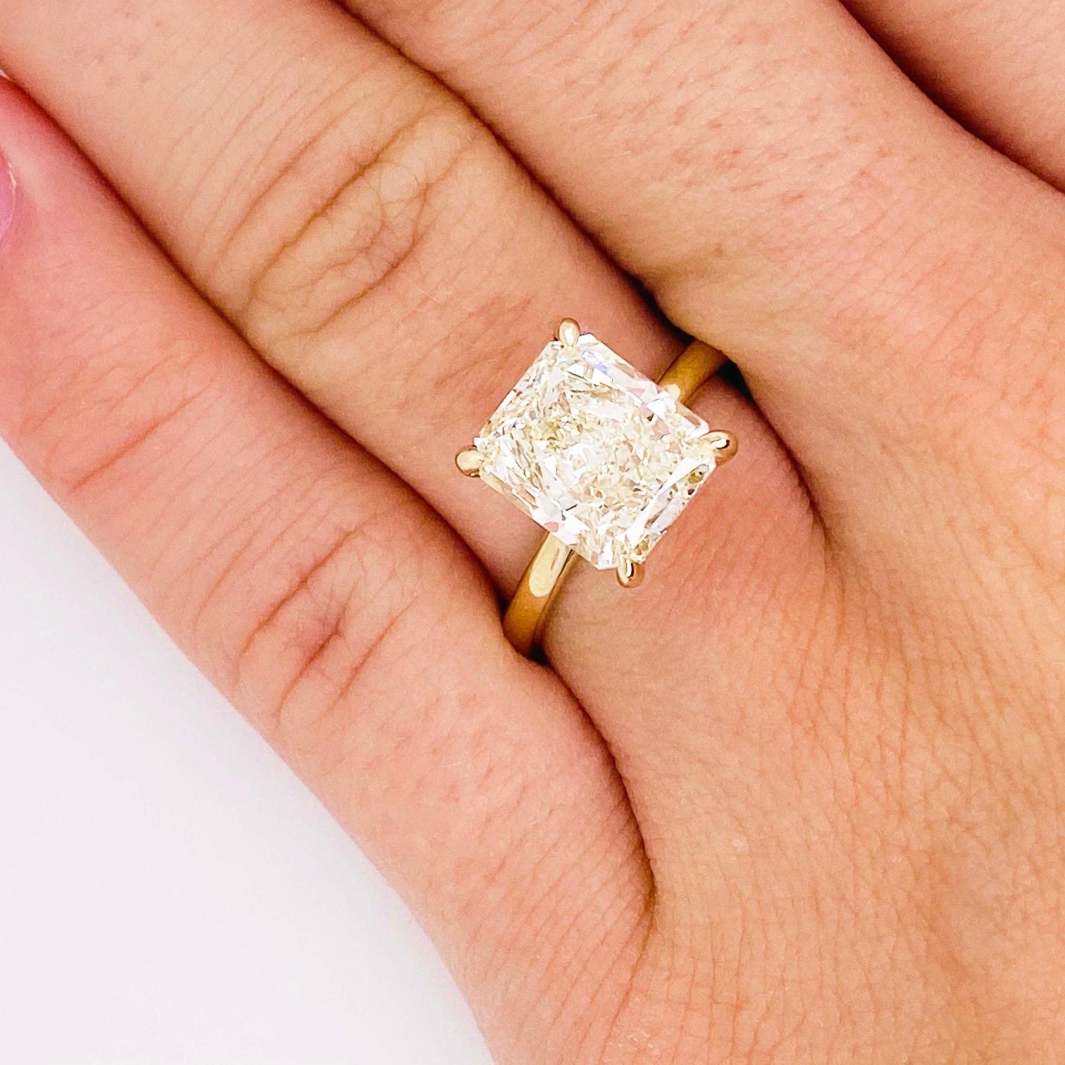 Gorgeous diamond solitaire engagement ring! With a GIA certified 3.00 carat, radiant cut diamond set in 4 elegant pointed prongs (or claw prongs)! The 14k yellow gold engagement ring is the perfect compliment to this stunning radiant diamond.