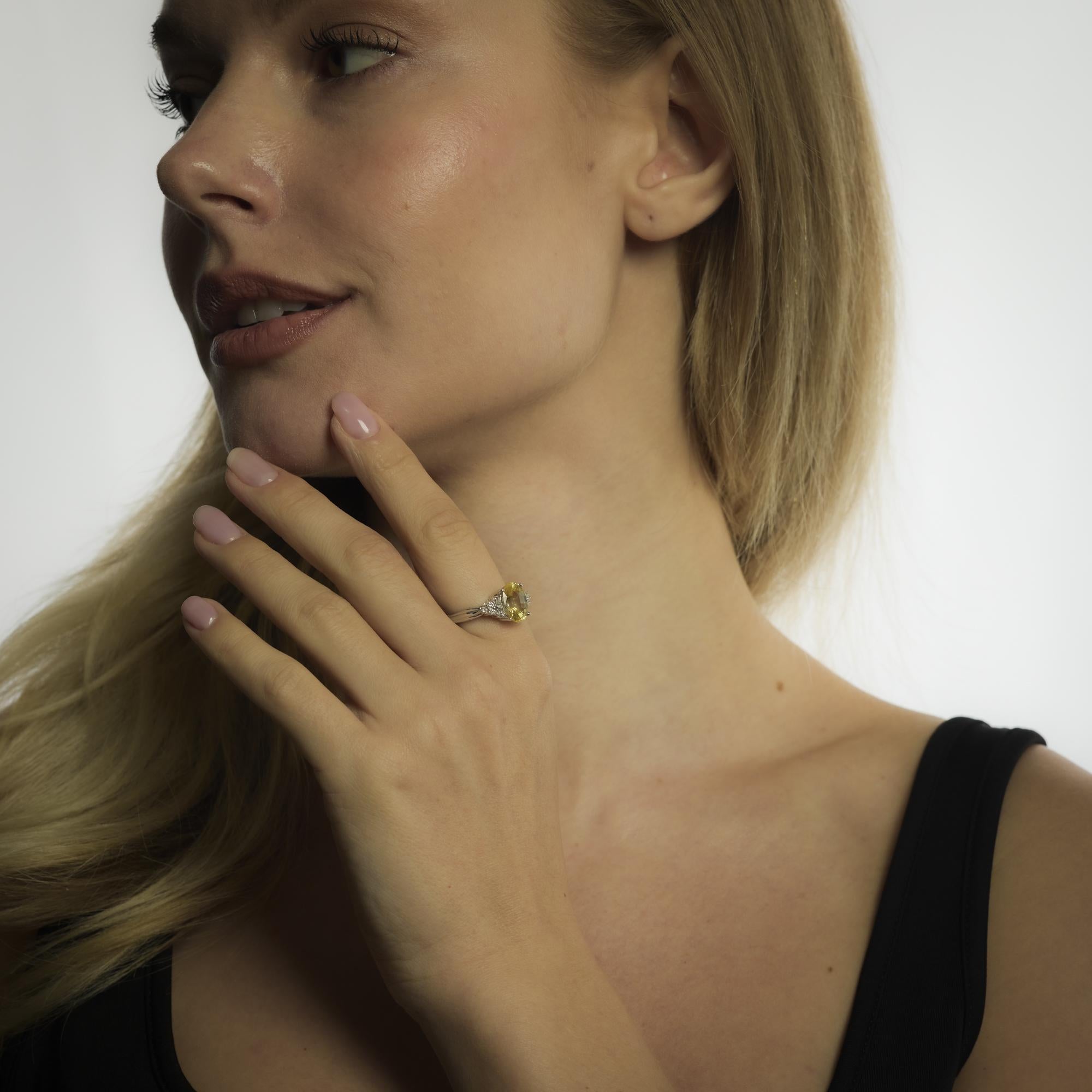 A vibrant 3.90 carat Ceylon yellow sapphire radiates warmth in this Mid Century ring, accented by tapered diamond baguettes in a refined 10k white gold setting.