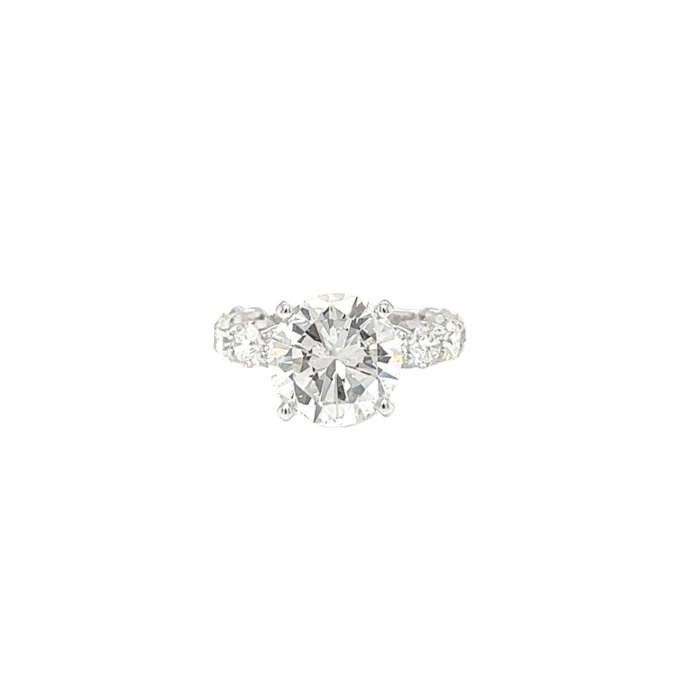 This Stunning Diamond ring is accompanied by a GIA Certified report certifying that 3.95ct Round Cut Natural Diamond with Si1 clarity, I color Diamond Ring is made in 18K White Gold, with 2ct side round Diamonds G Color and  VS1 clarity. This ring