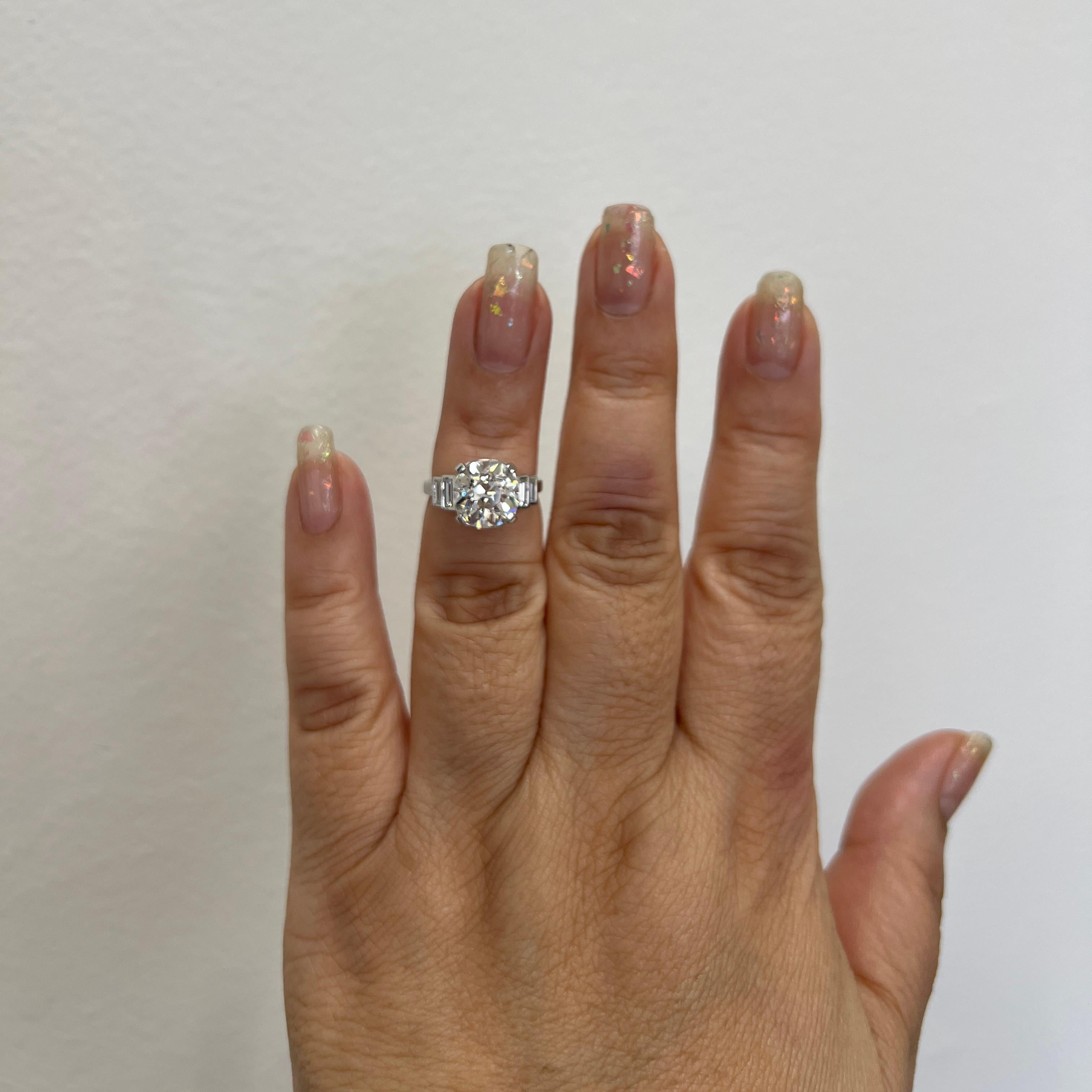 Gorgeous 4.00 ct. K SI1 old European white diamond with good quality white diamond emerald cuts on the side.  Handmade in platinum.  Ring size 5.25.  GIA report is included.