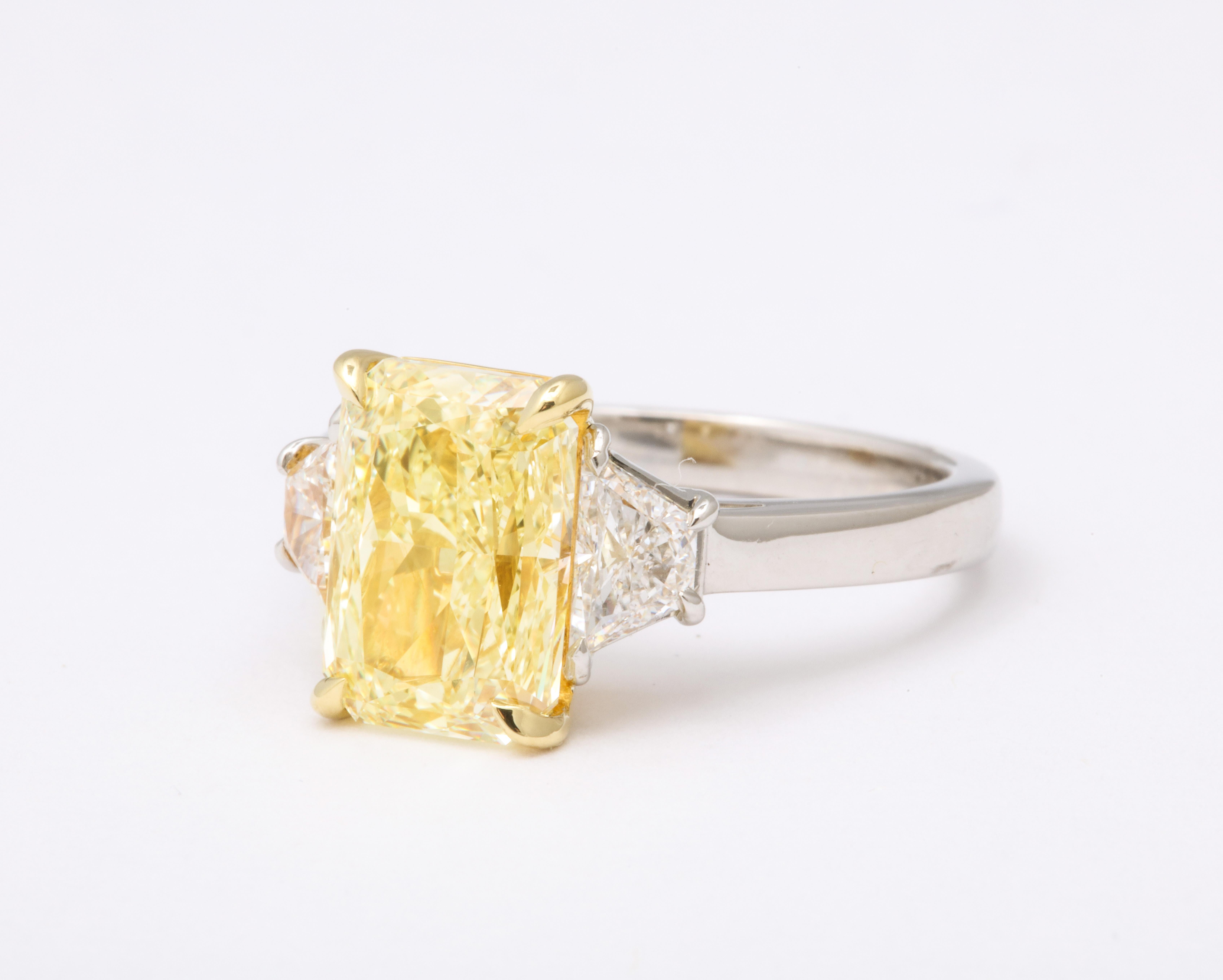 
A beautiful yellow diamond ring -- the most sought after elongated shape center diamond!

A beautiful rectangular 4.01 carat Radiant cut Fancy Light Yellow GIA certified center diamond. 

The center stone is nearly flawless -- VVS2 clarity! 

.72