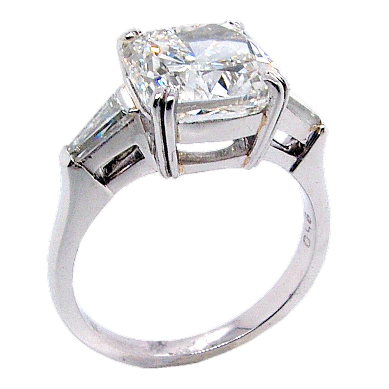 A beautiful square Cushion Cut H/VS2 GIA certified center Diamond set in a fine Platinum 3 stone Engagement Ring with 2 Baguette diamonds the side. Total diamond weight of 0.37 Ct. on the side. 

Diamond specs:
Center stone: 4.01 Ct GIA Certified
