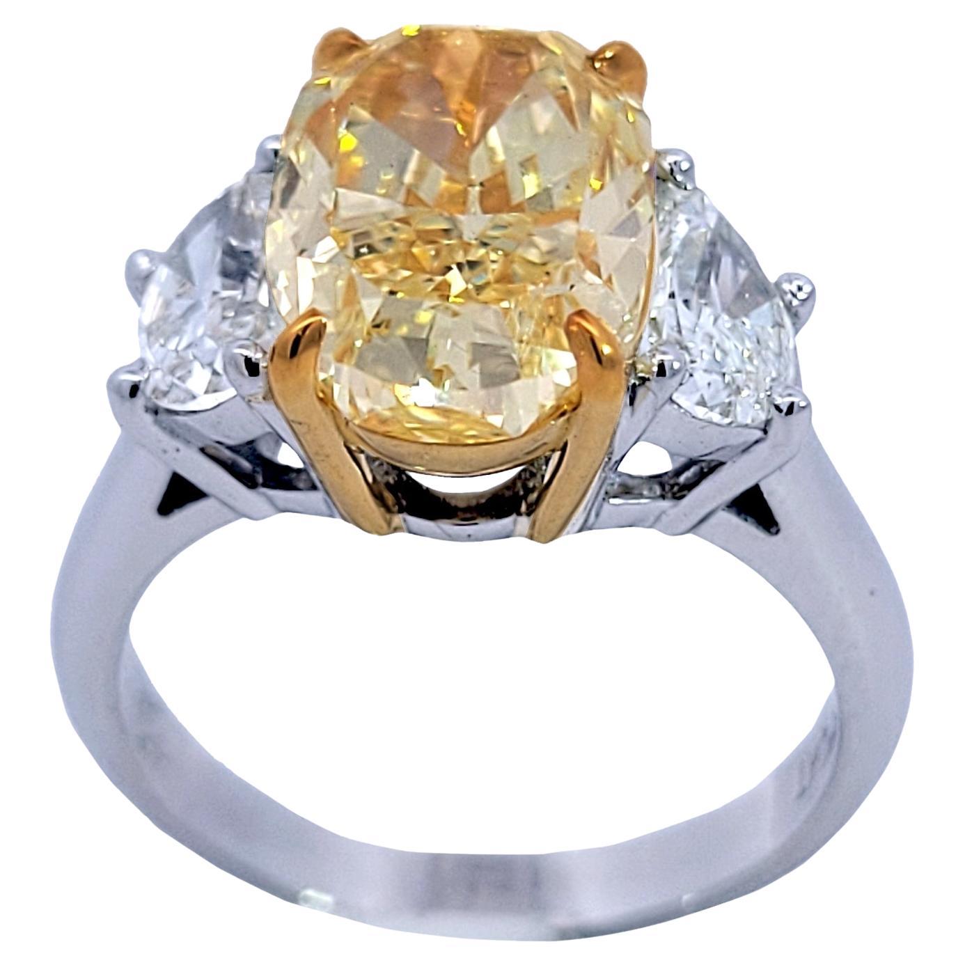 GIA 4.03 Ct Fancy Yellow Oval Diamond 3 Stone Platinum/18K Engagement Ring For Sale