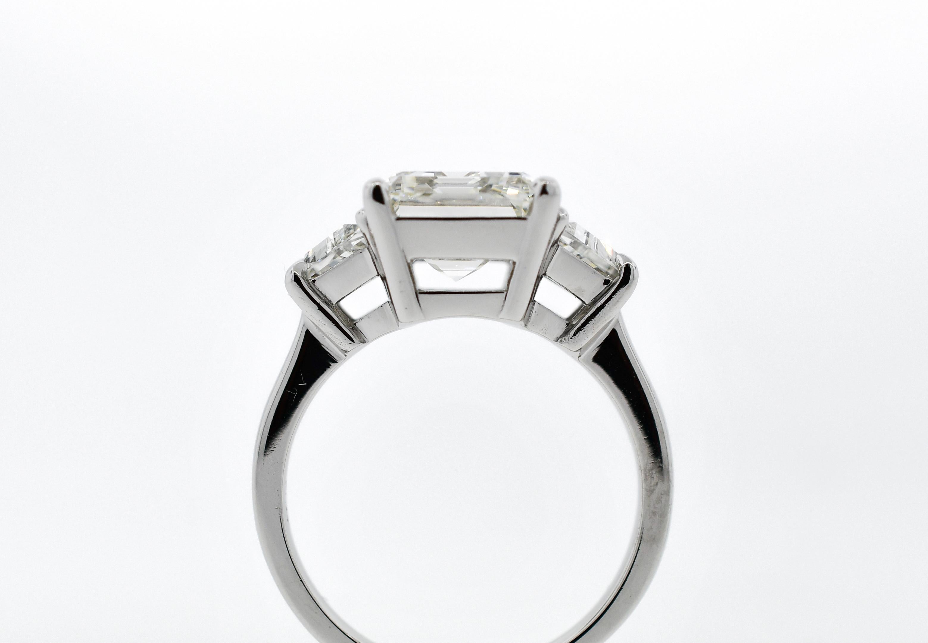 Contemporary GIA 4.05 Carat Emerald Cut Diamond Three-Stone Ring For Sale