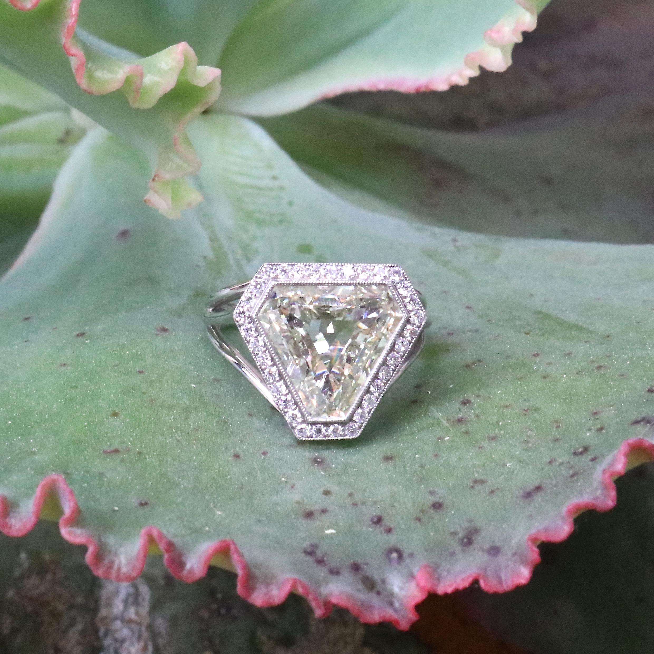 Engagement ring? This will be remembered long after the wedding party. Some will like the boldness of the ring, others will not. It's not for the faint of heart. Be a trendsetter if you dare. Featuring a GIA triangular step cut diamond, certified as