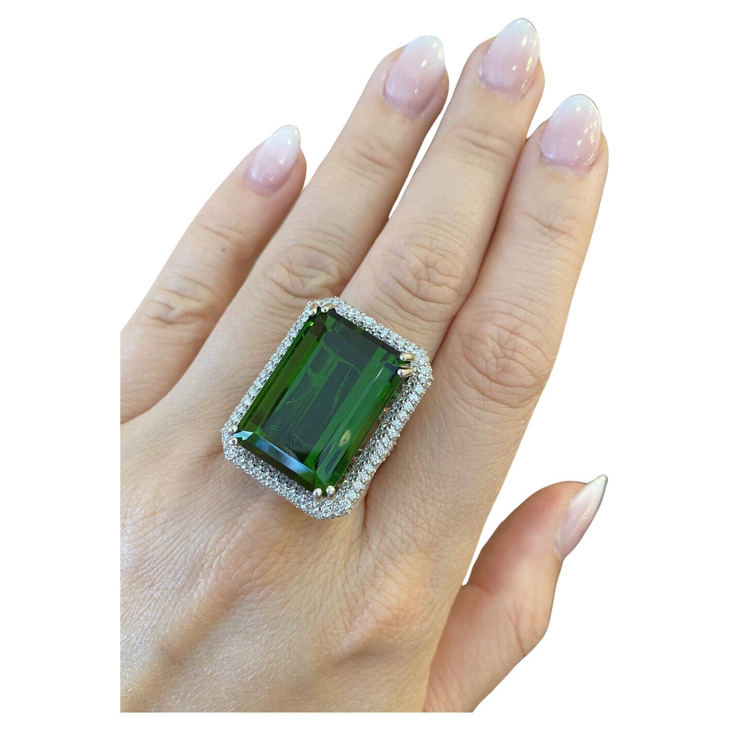 GIA Certified 40.87 Carat Green Tourmaline in Pave Diamond Ring in 18k White Gold

Green Tourmaline and Diamond Ring features a large Rectangular Emerald Cut Green Tourmaline surrounded by Round Brilliant cut Diamonds pave set in 18k White