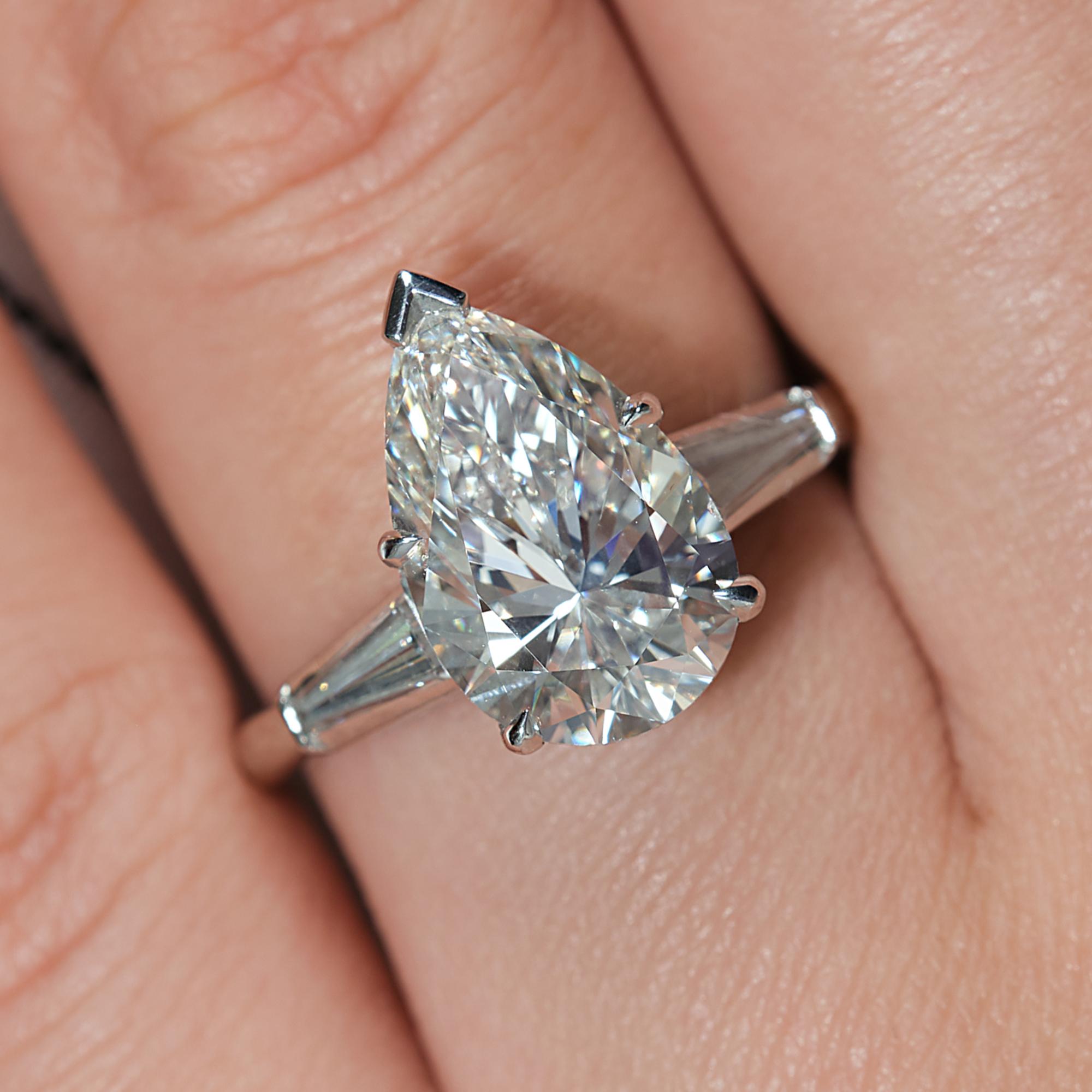 This a Beautiful, the most timeless and classic style - Estate Vintage 3 Stone Pear Shaped Ring with 2 Large baguettes weighing in total 4.51ctw. 
Buy her this exquisite and the most classic, elegant diamond ring which will go beyond her