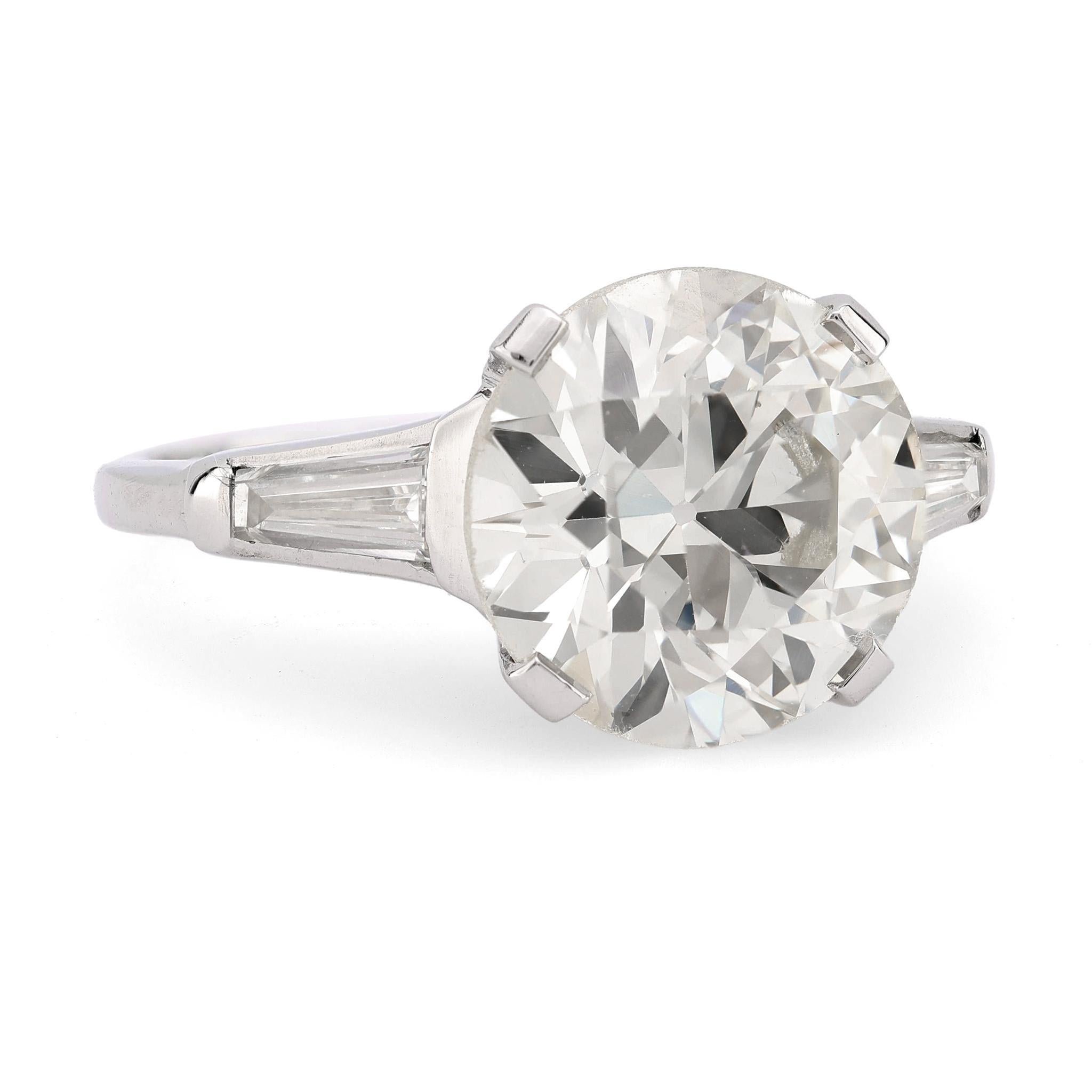 This Mid Century platinum engagement ring showcases a dazzling 4.33-carat old European diamond flanked by baguette accents. A timeless design with remarkable brilliance.

Certificate: GIA #2235416067
Center stone: Circular brilliant cut diamond
