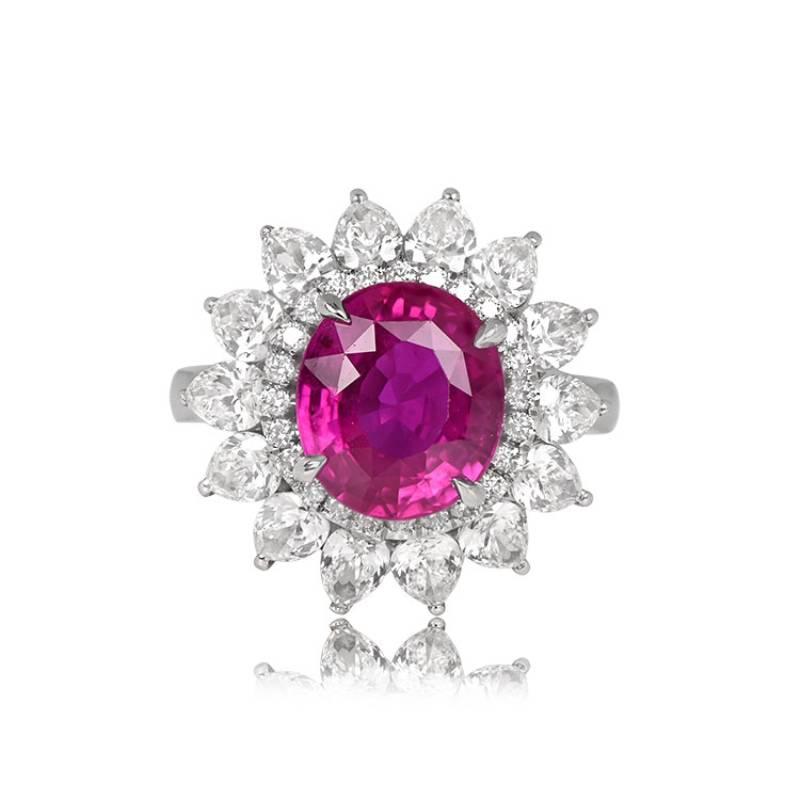 A platinum ring showcases a GIA-certified 4.47-carat oval-cut natural pink sapphire in prong settings. The center stone is encircled by a floral motif, with a halo of single-cut diamonds and a second halo of bezel-set pear-shaped diamonds, totaling