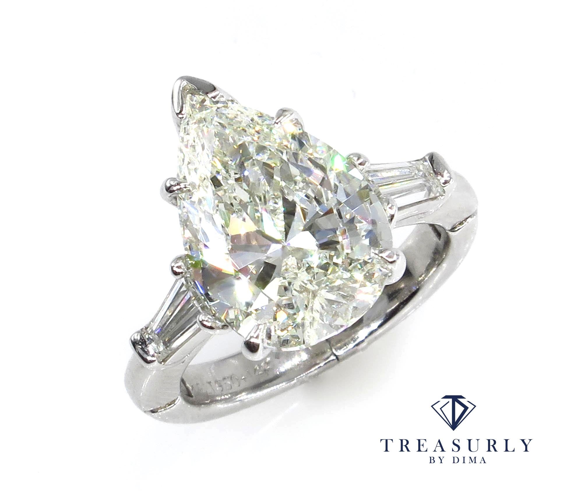 This a Beautiful, the most timeless and classic style - Estate Vintage 3 Stone Pear Shaped Ring with 2 Large baguettes weighing in total 4.51ctw.
Buy her this exquisite and the most classic, elegant diamond ring which will go beyond her dreams!
Your
