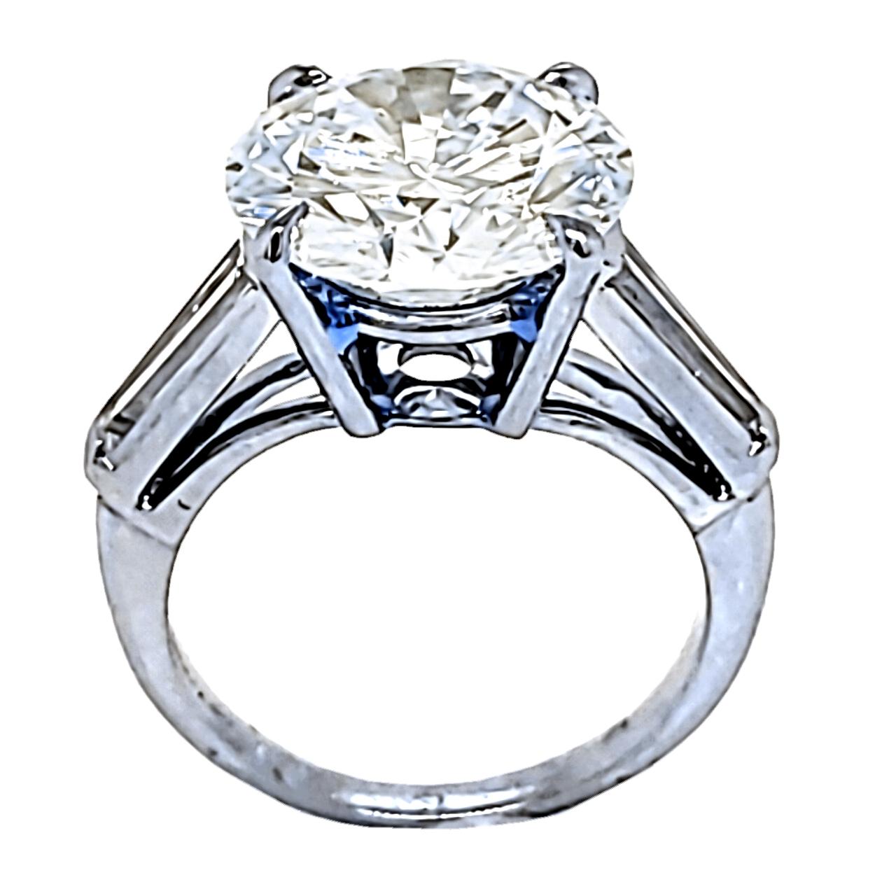 A shiny 4.64 Ct Round Brilliant K/VS1 GIA Certified center Diamond set in a fine Platinum 3 Stone Engagement Ring with two Long Tapered Baguette diamonds on the side. Total diamond weight of 0.40 Ct. on the side. 

Center stone: 4.64 Ct GIA