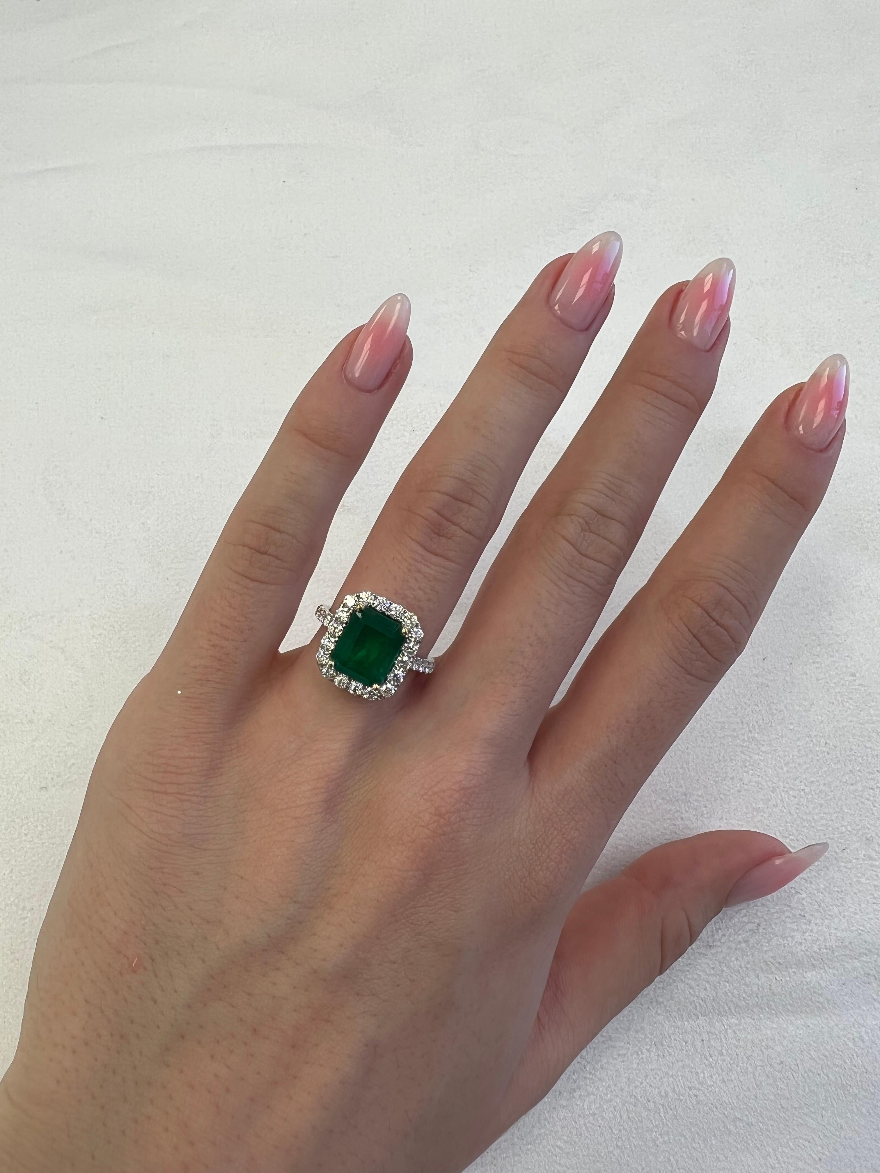 Classic emerald and diamond halo ring, GIA certified. 
4.68 carats total gemstone weight.
3.60 carat emerald cut emerald, F2, GIA certified. Complimented by 30 round brilliant diamonds, 1.08 carats, F/G color and VS clarity. 18k white and yellow