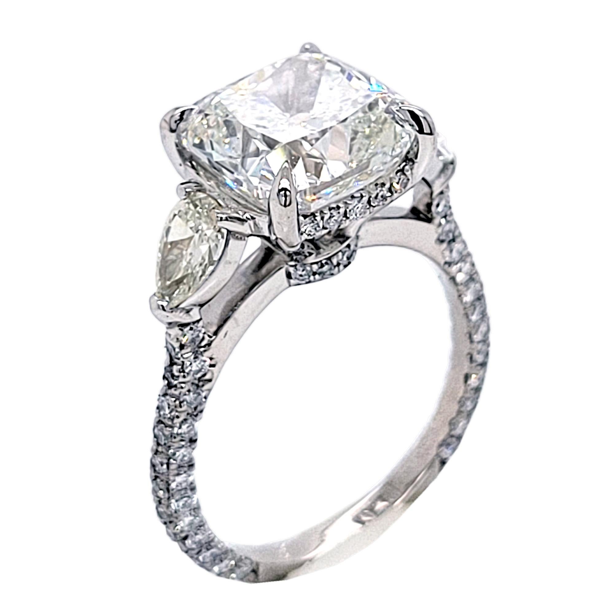 A beautiful GIA Certified 4.75 Ct Square Cushion Cut I/VS1 center Diamond set in a fine Pave Set Platinum 3 stone Engagement Ring with 2 Pear Shape diamonds the side with Hidden Halo. Total diamond weight of 1.29 Ct. diamonds on the side. 

Diamond